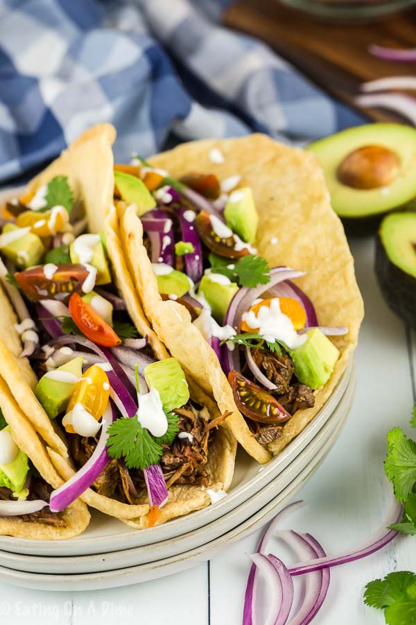 Enjoy Crock pot shredded beef tacos loaded with tender beef. The slow cooker does all of the work and all you need to do is add your favorite toppings! 