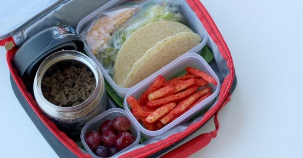 Close up image of taco ingredients in a lunch box. 