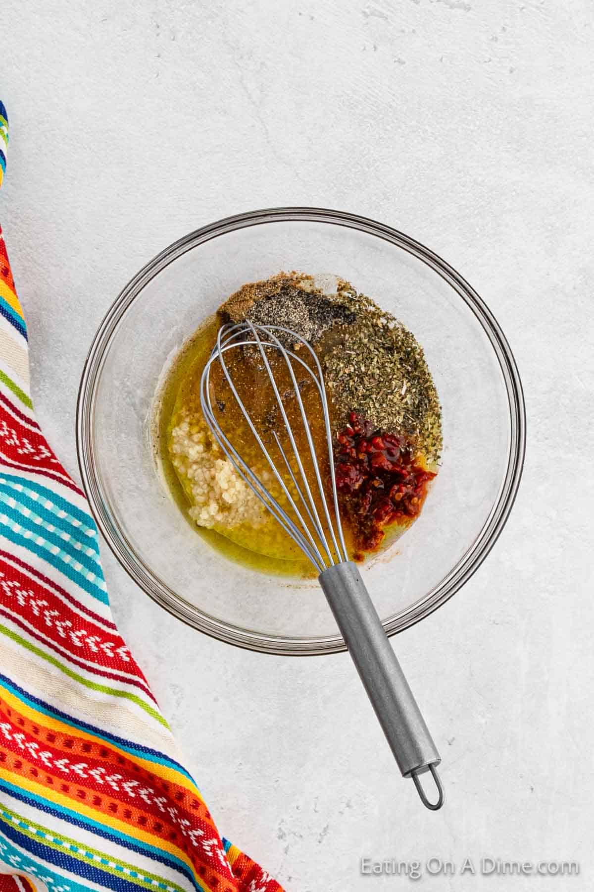 Combining marinade ingredients in a bowl with a whisk