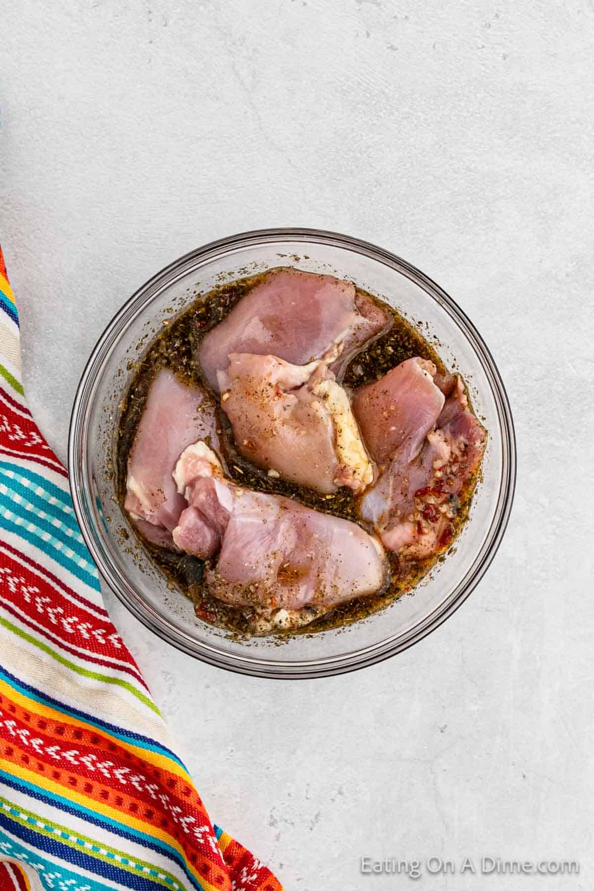 Chicken thighs in a bowl with the marinade