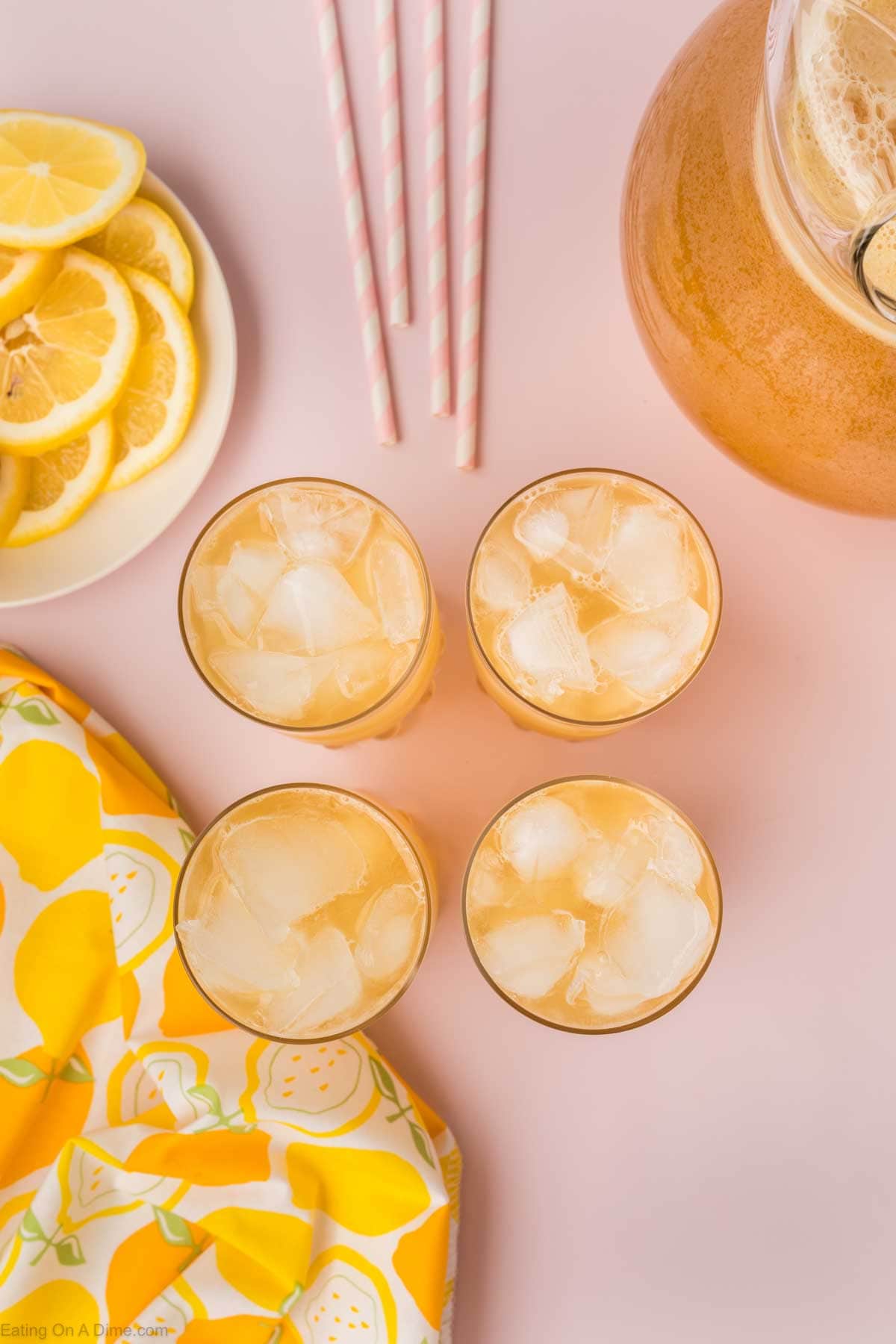 Glasses of lemonade with ice and a plate of lemon slices