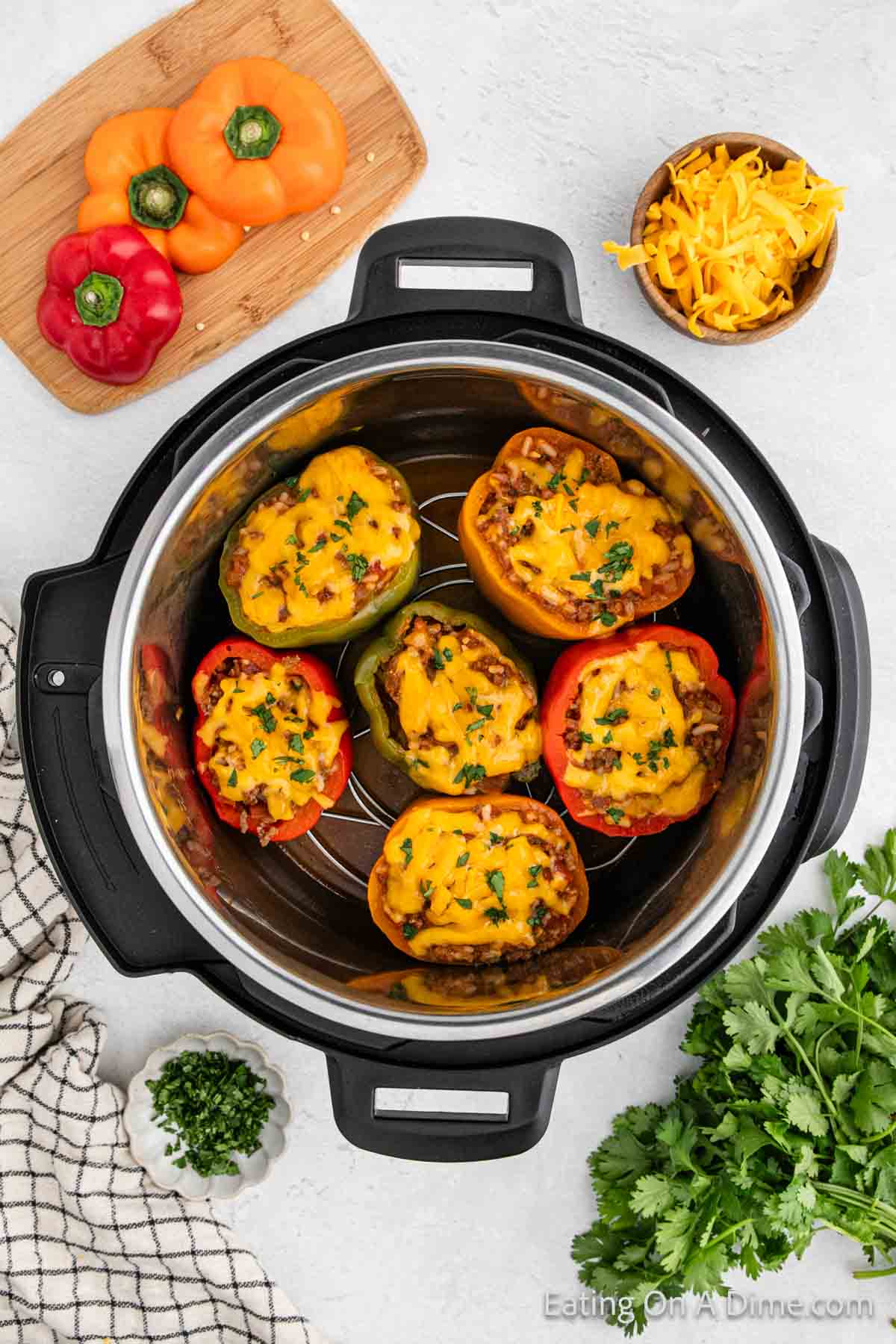 Bell peppers in instant pot stuffed with ground beef mixture and melted cheese 