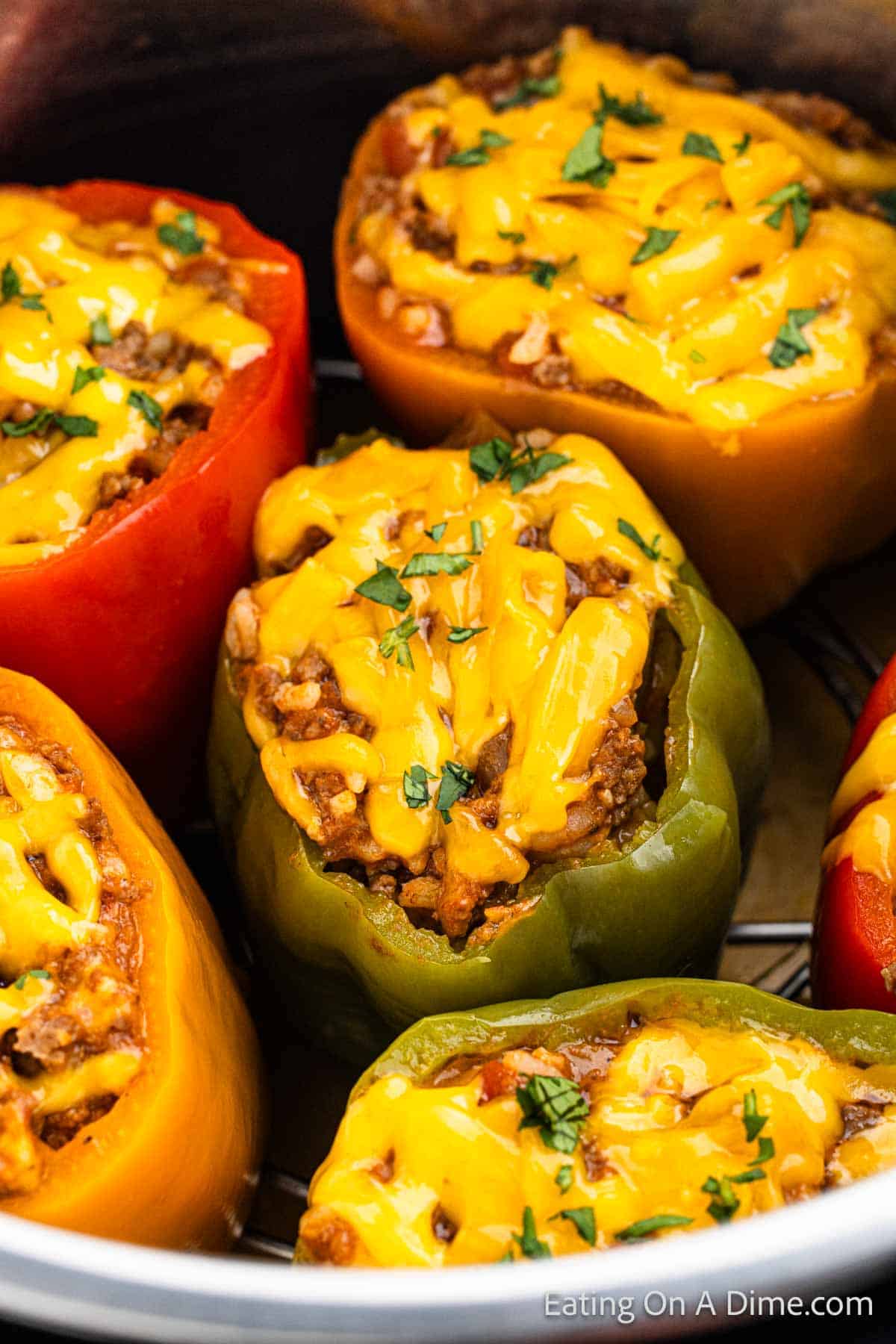 Stuffed peppers in instant pot stuffed with ground beef mixture and topped with melted cheese