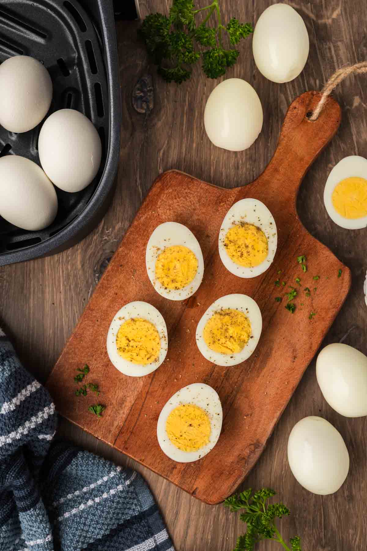 Hard boiled eggs cut in half on a cutting board