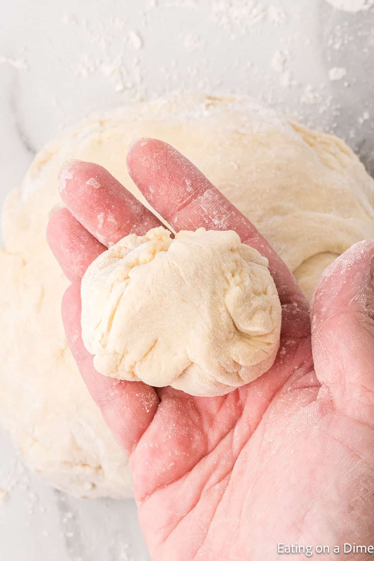 A small piece of dough in a hand