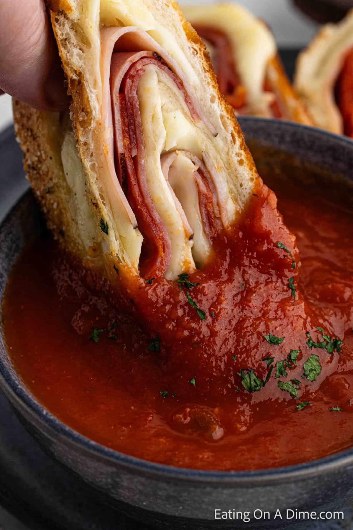 Dipping the stromboli with sauce