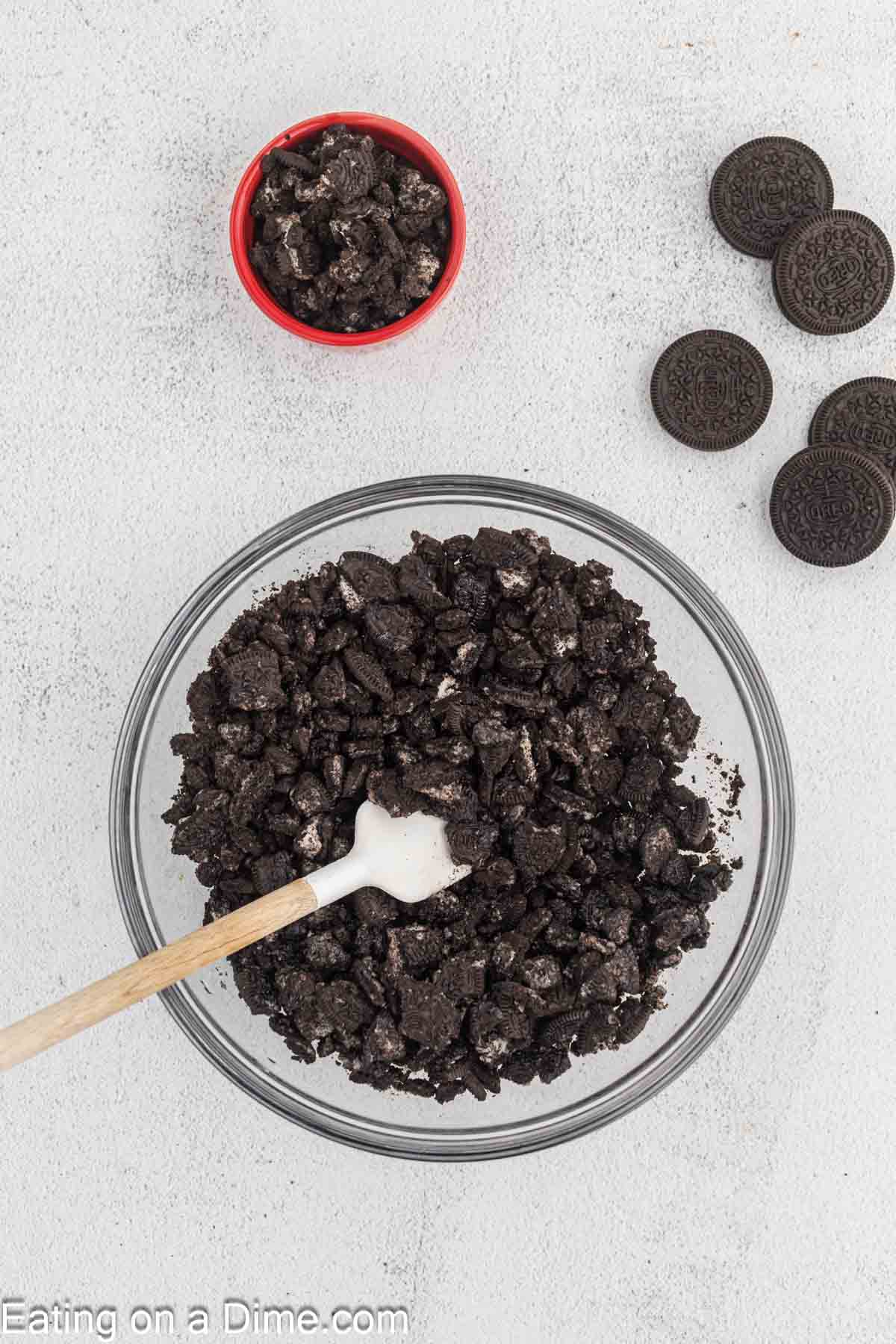 Crushed Oreos in a bowl with a side of a small bowl of Crushed Oreos 