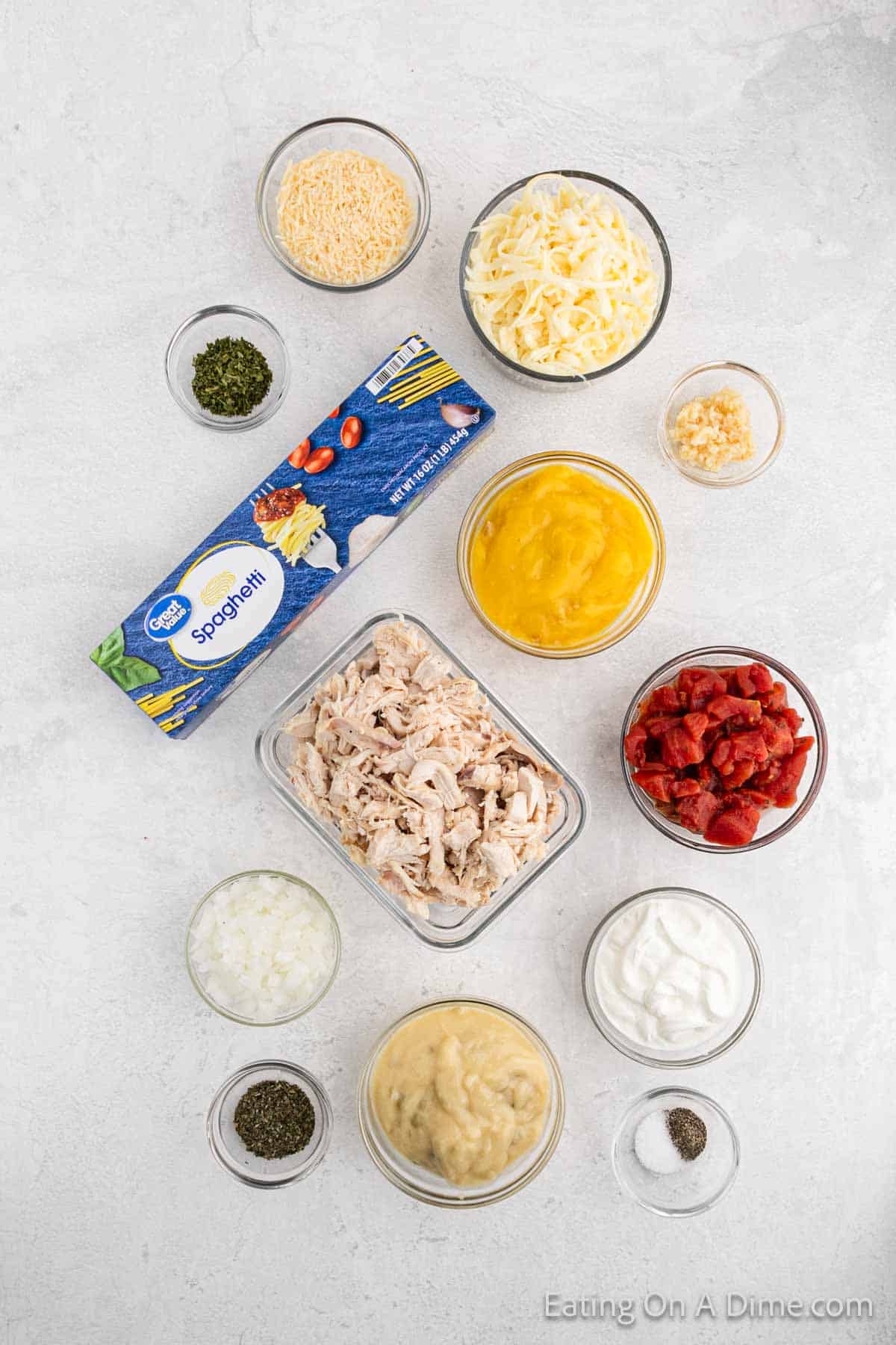 Ingredients - chicken, diced tomatoes, celery soup, chicken soup, onion, garlic, dried parsley, basil, sour cream, monterey jack cheese, spaghetti, salt, pepper, parmesan cheese