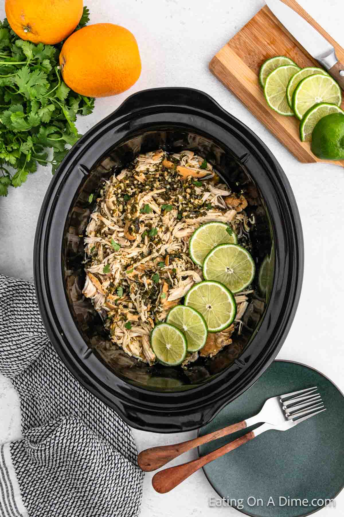 Shredded chicken in the slow cooker with fresh lime slices