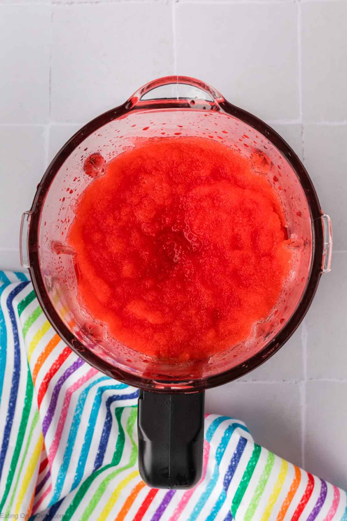 Blended red slushie mixture in the blender