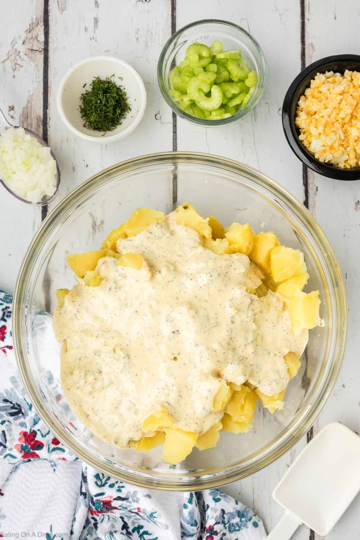 Soft potatoes in a bowl topped with mayo mixture 