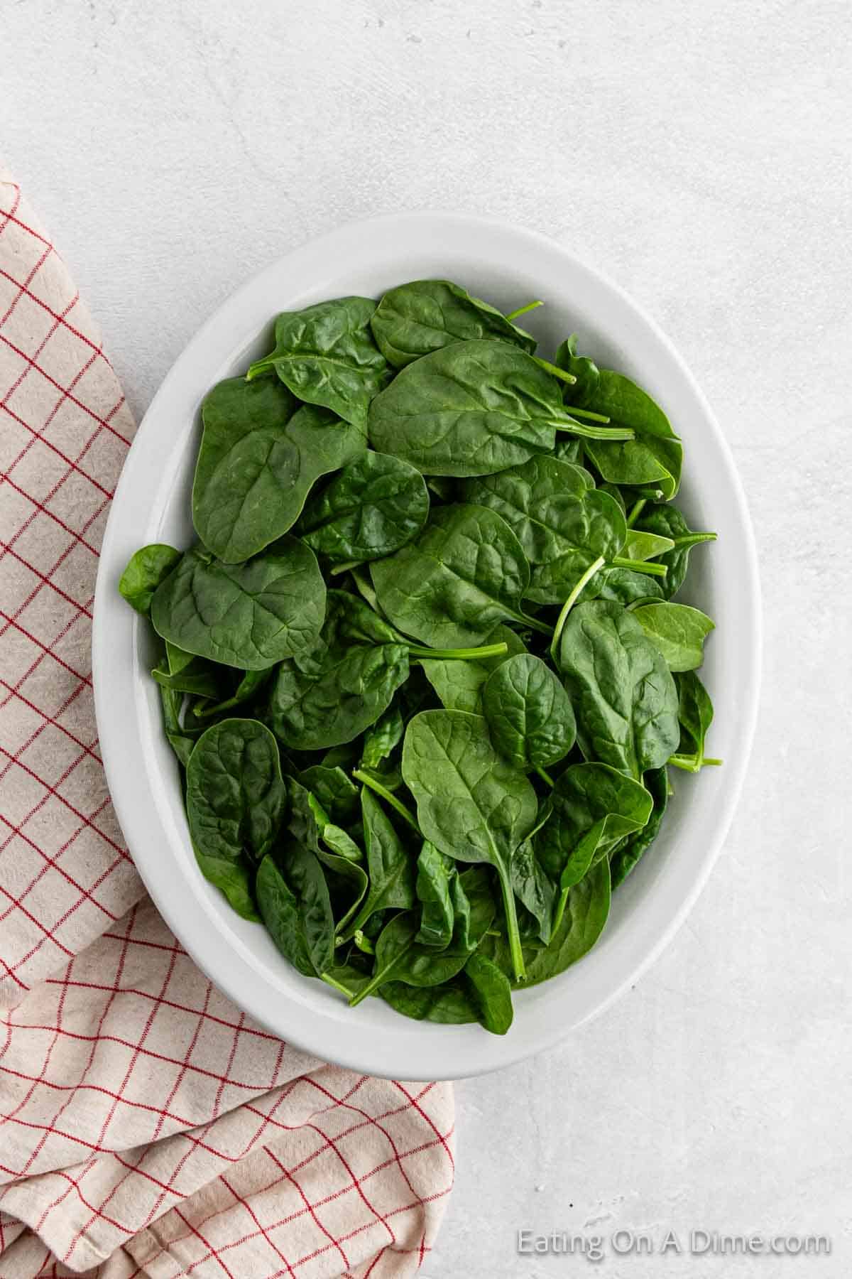 Fresh spinach in a white bowl