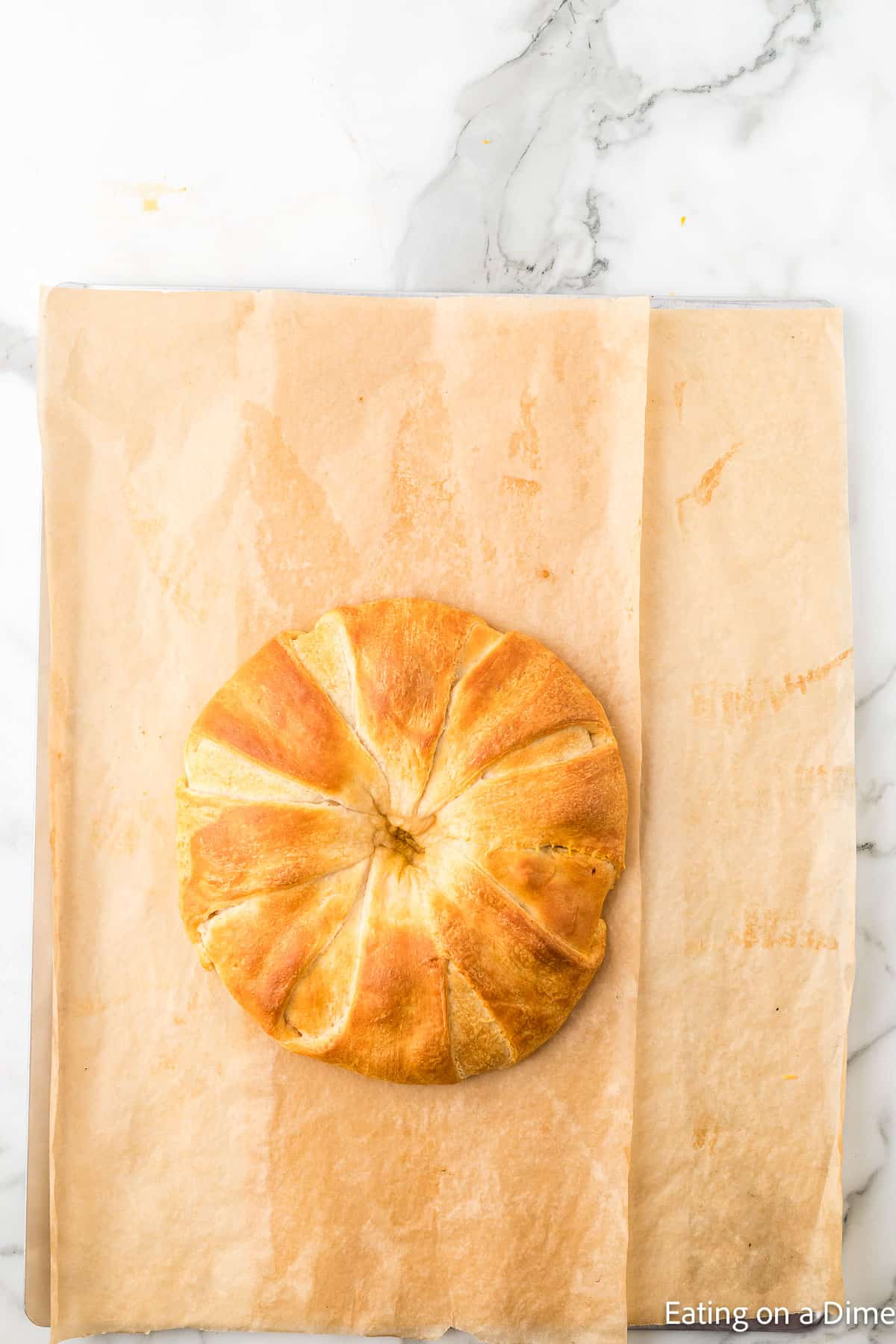 Baked crescent roll taco ring on baking sheet lined with parchment paper