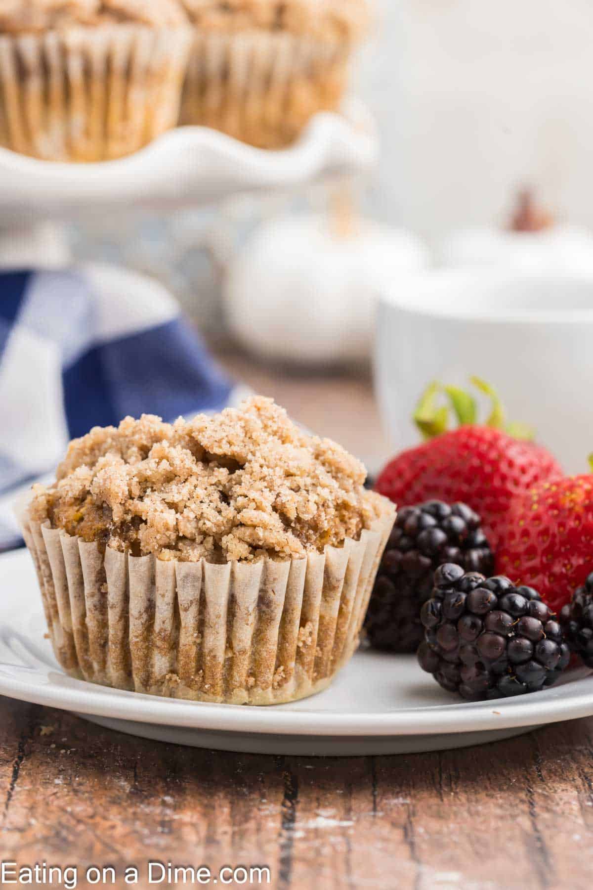 Pumpkin Streusel Muffins on a plate with fresh strawberries and fresh blackberries