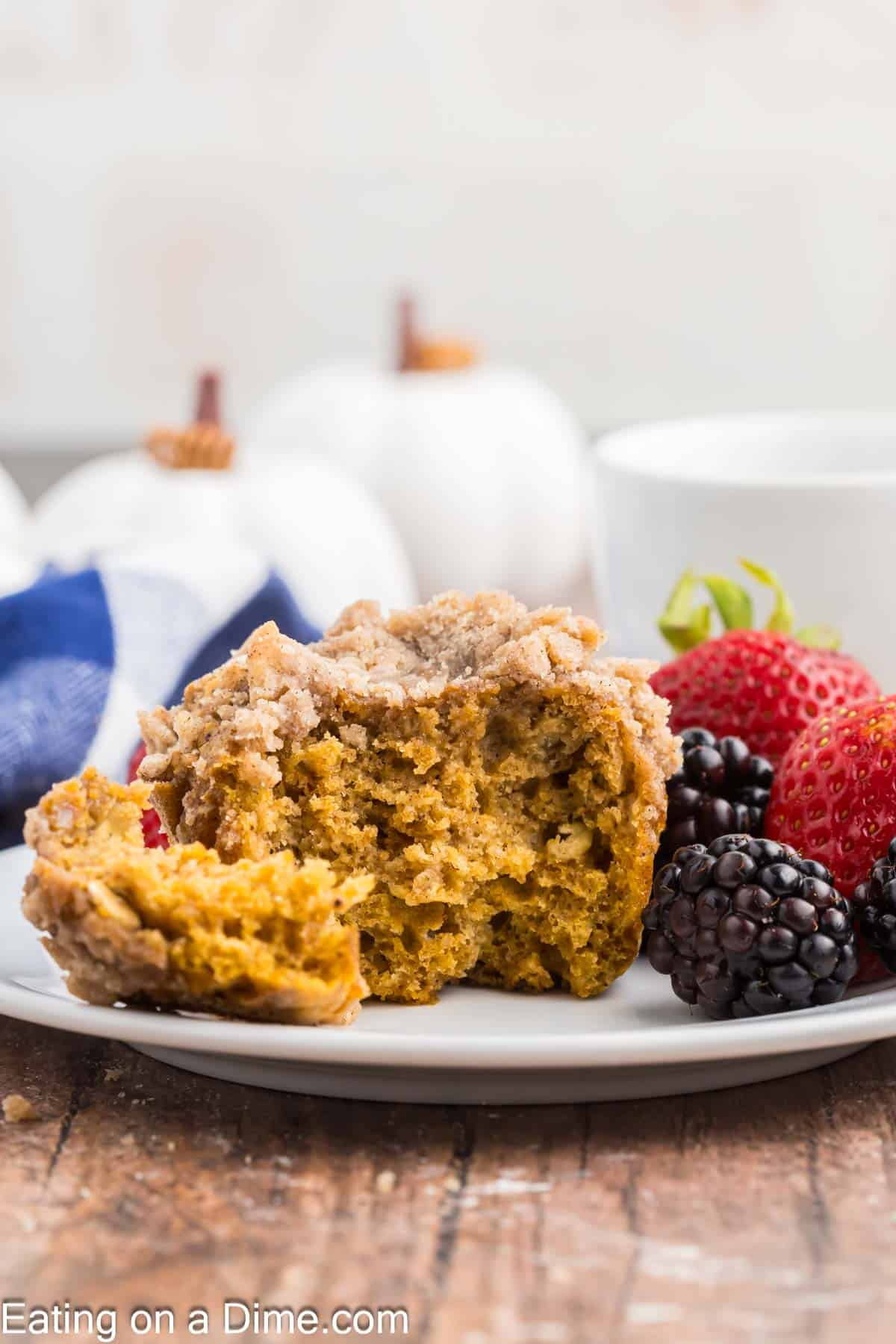 Pumpkin streusel muffins on a plate with blackberries and strawberries