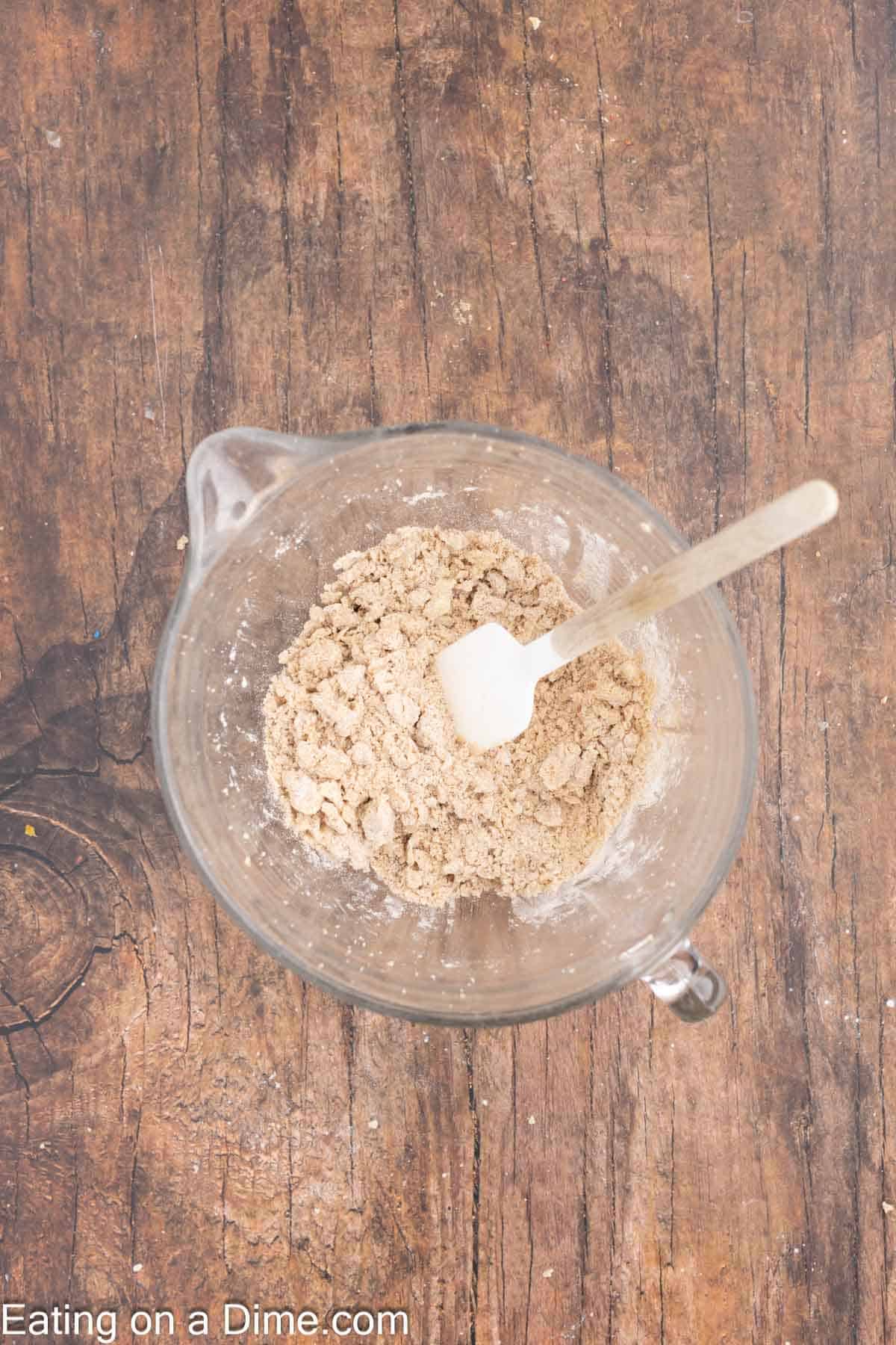 Combining the streusel ingredients together in a bowl with a spatula