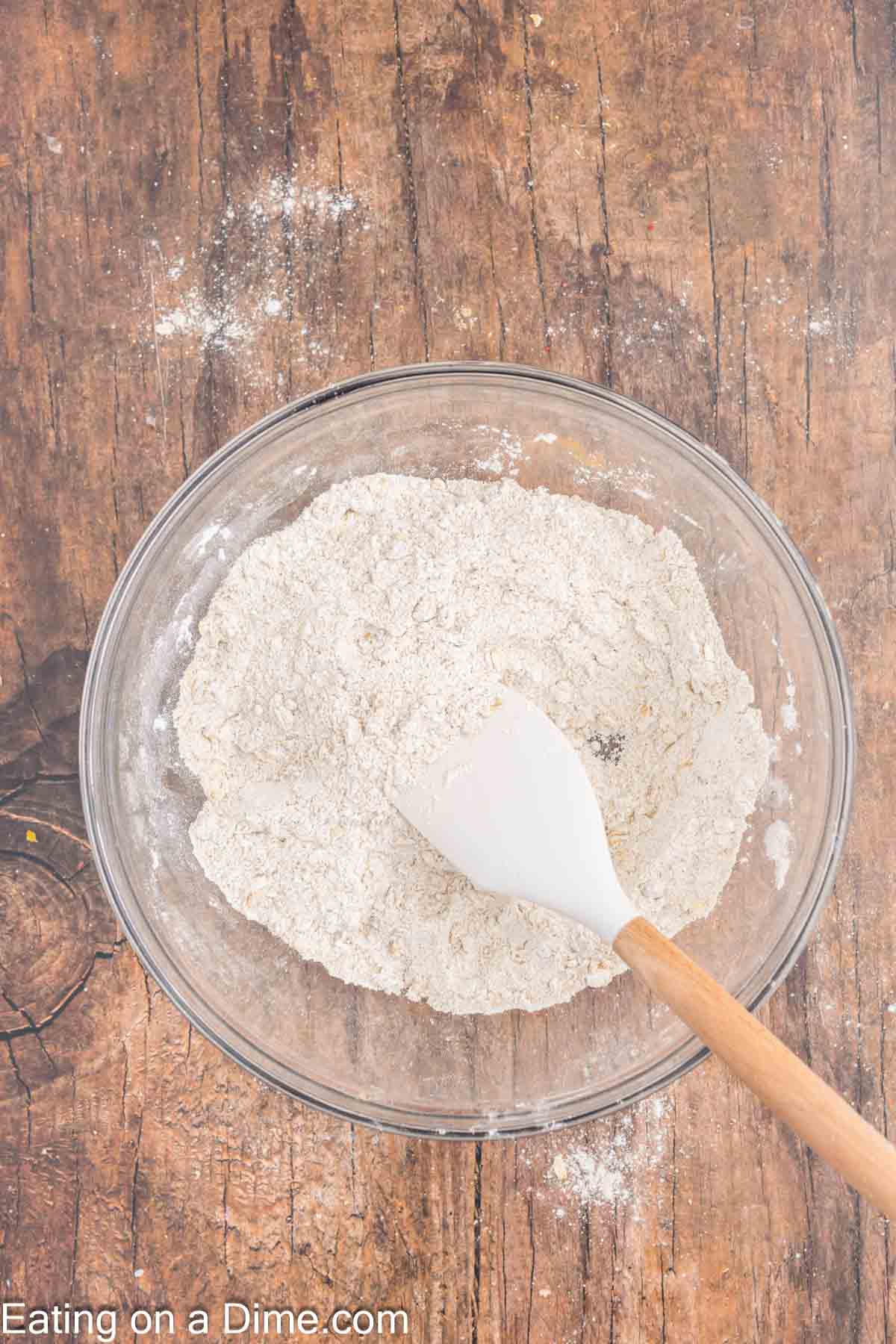 Combining the dry ingredients in a bowl with a spoon