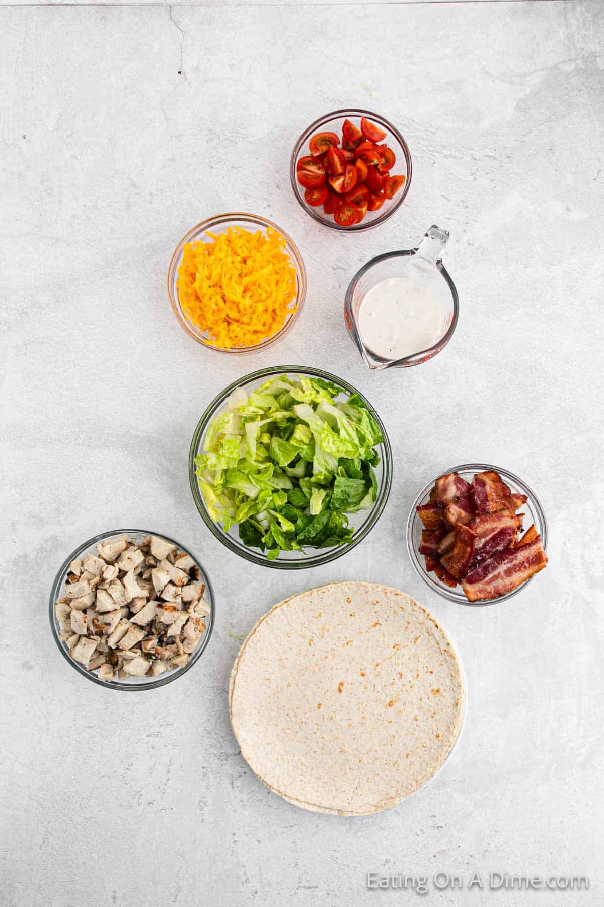 Ingredients - cooked chicken, bacon, ranch dressing, cheese, lettuce, cherry tomatoes, wraps