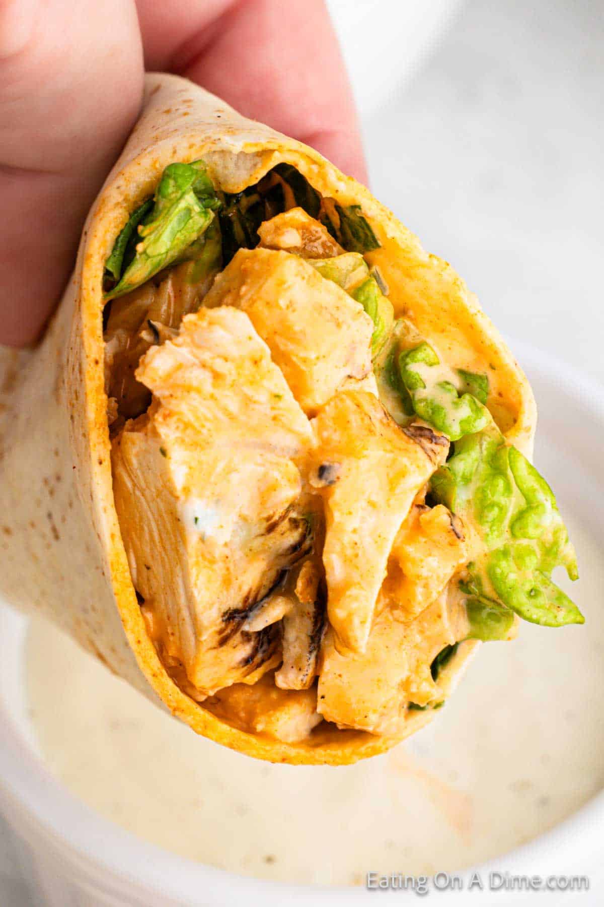 Buffalo Chicken Wrap up close showing the buffalo chicken and lettuce