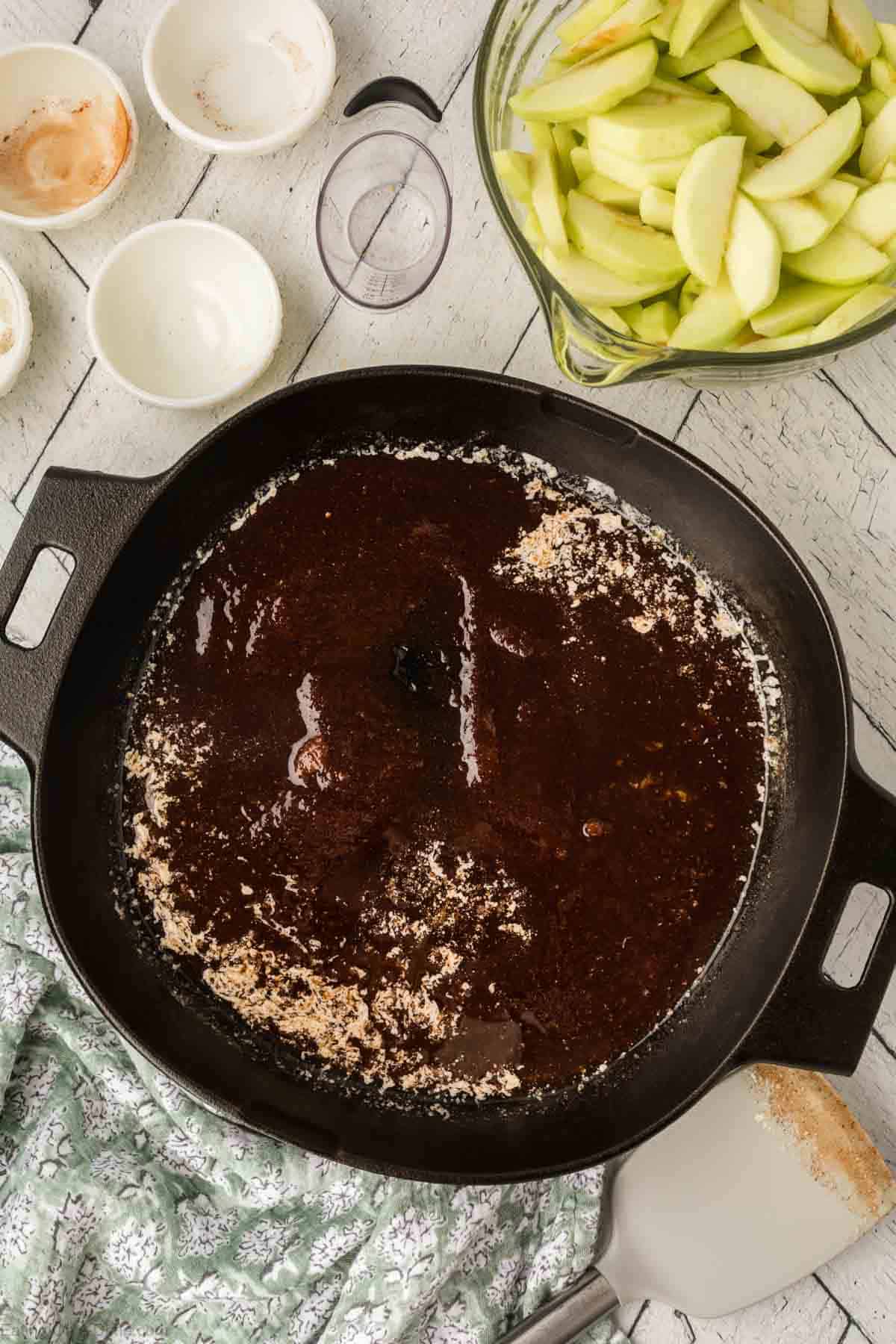 Melted butter and brown sugar mixed together in a cast iron skillet