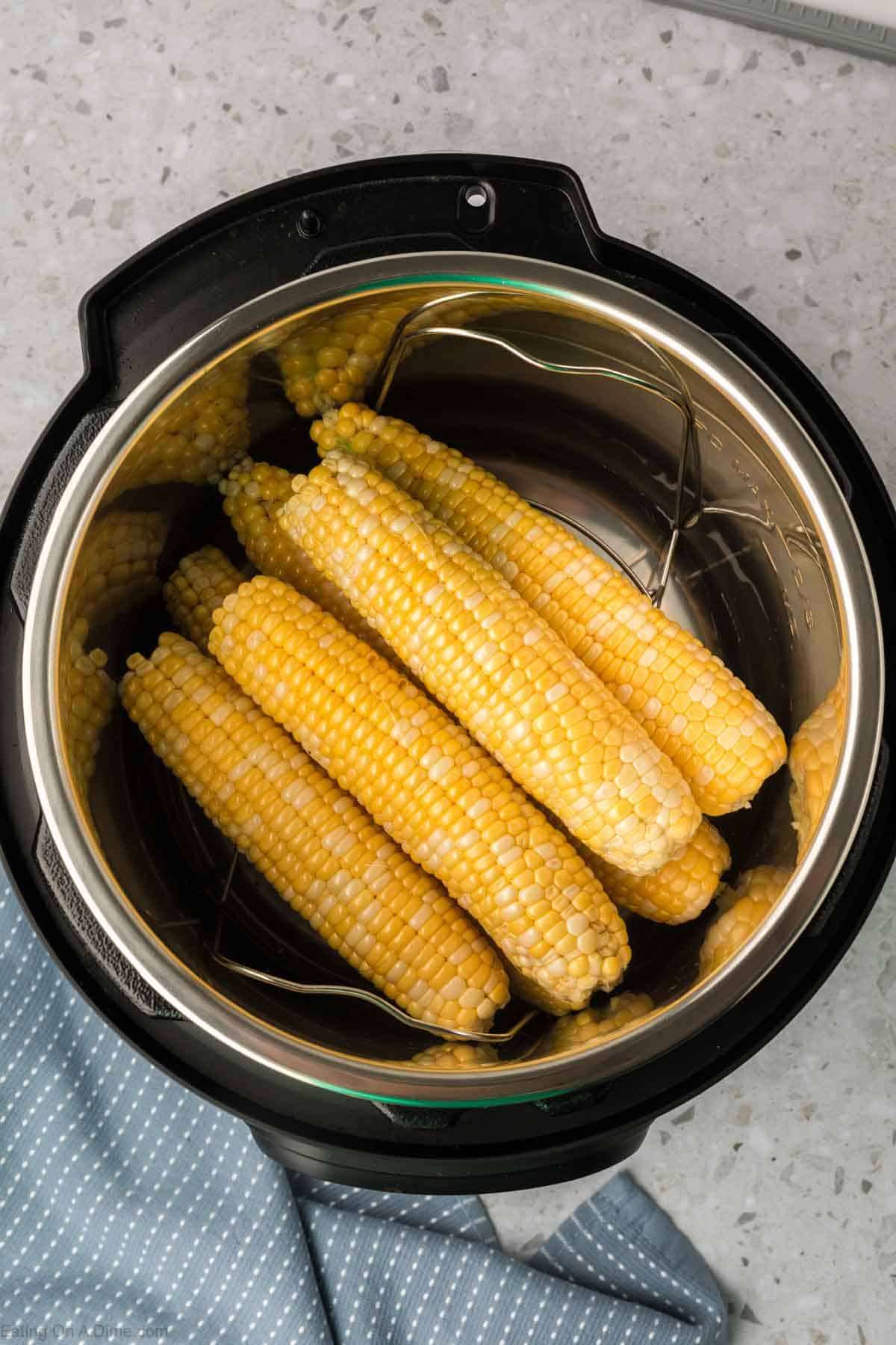 Placing the corn on the cob in the instant pot 