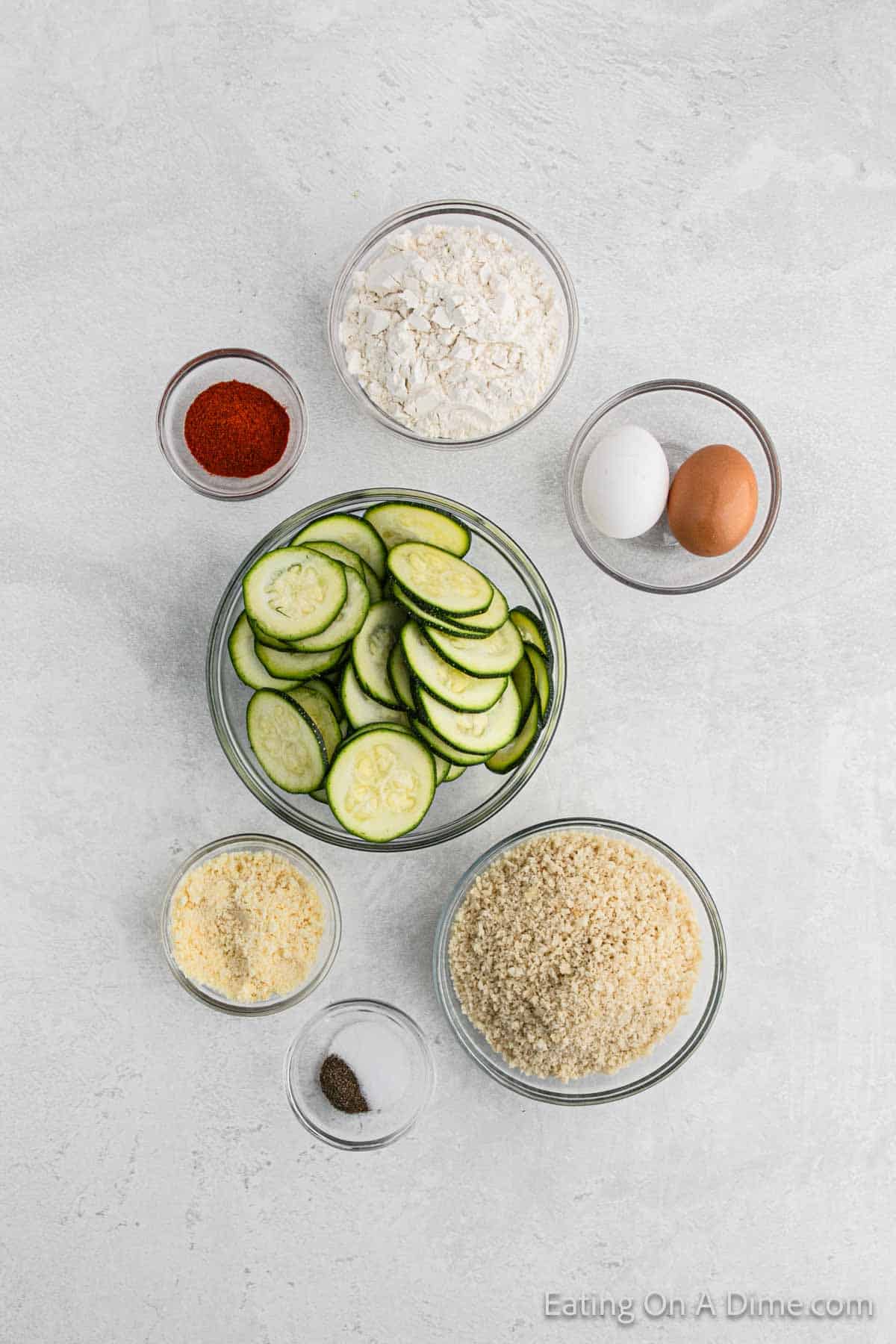 Ingredients - Zucchini, flour, paprika, salt, pepper, breadcrumbs, parmesan cheese, eggs