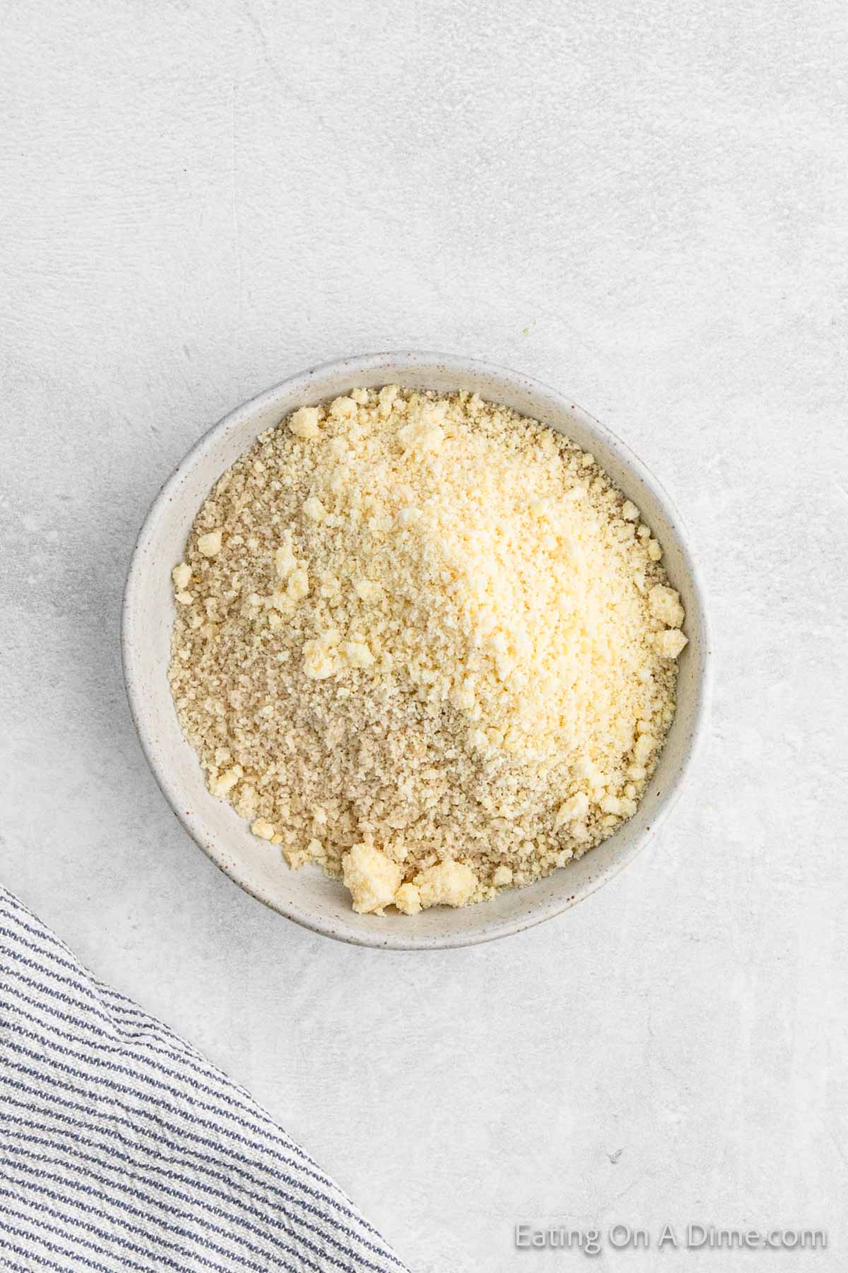 Breadcrumbs and parmesan cheese mixed together in a bowl