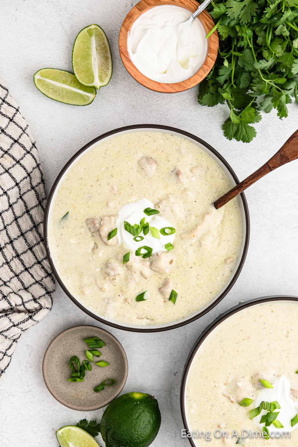 Keto Chicken Enchilada soup in a large bowl topped with sour cream and green onions