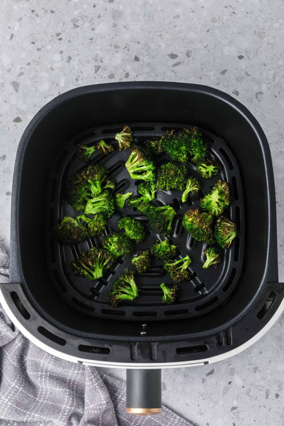Air fryer broccoli in the air fryer basket