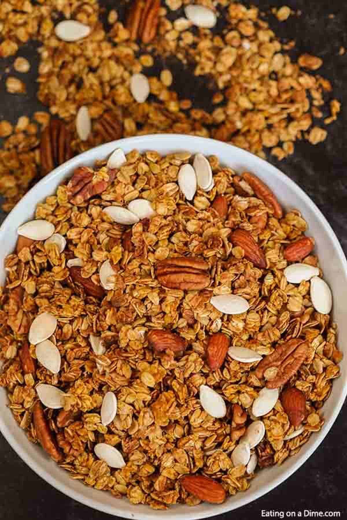 Pumpkin granola in a bowl mixed with oats, pecans, almonds and pumpkin seeds