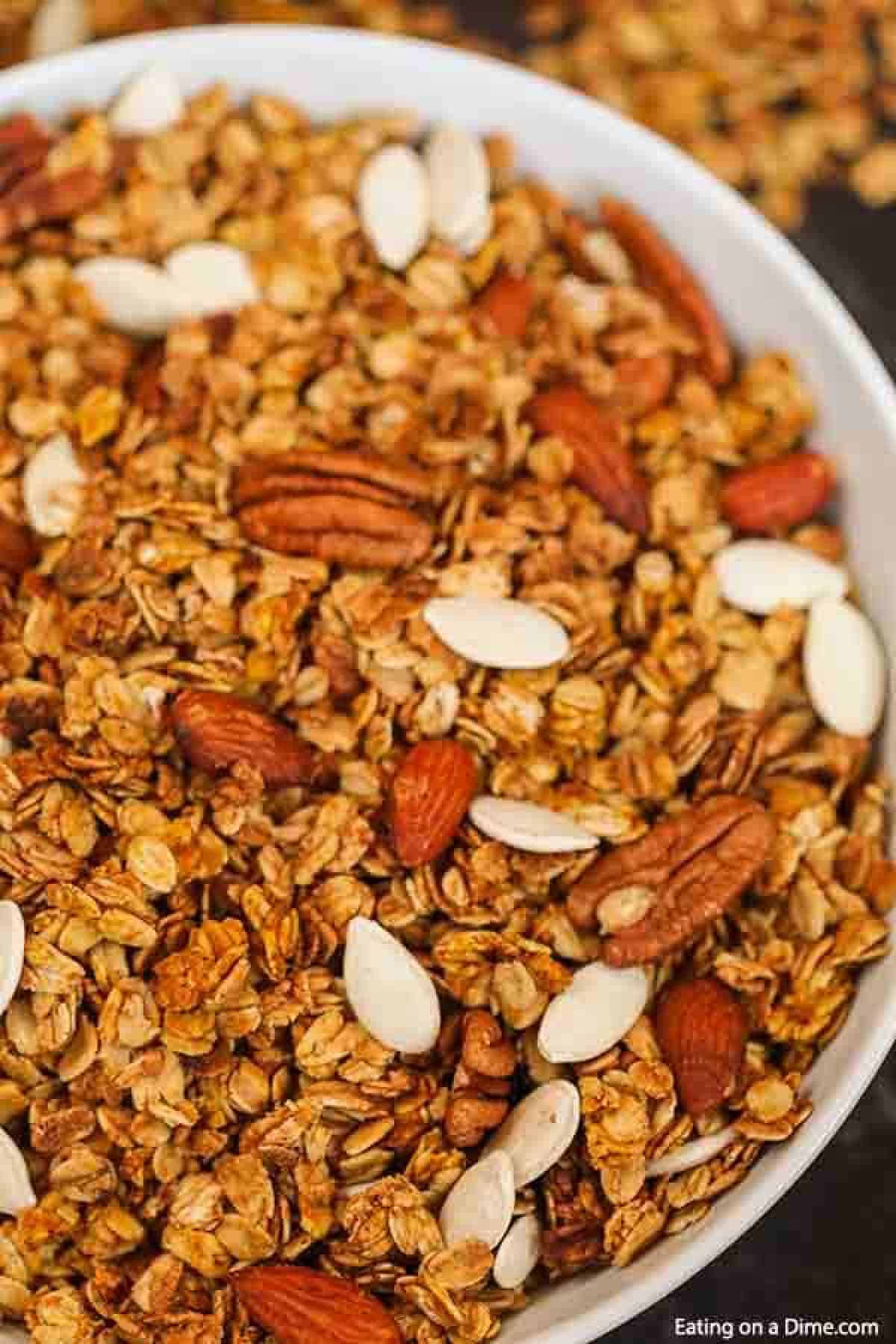 Pumpkin granola in a bowl mixed with oats, pecans, almonds and pumpkin seeds