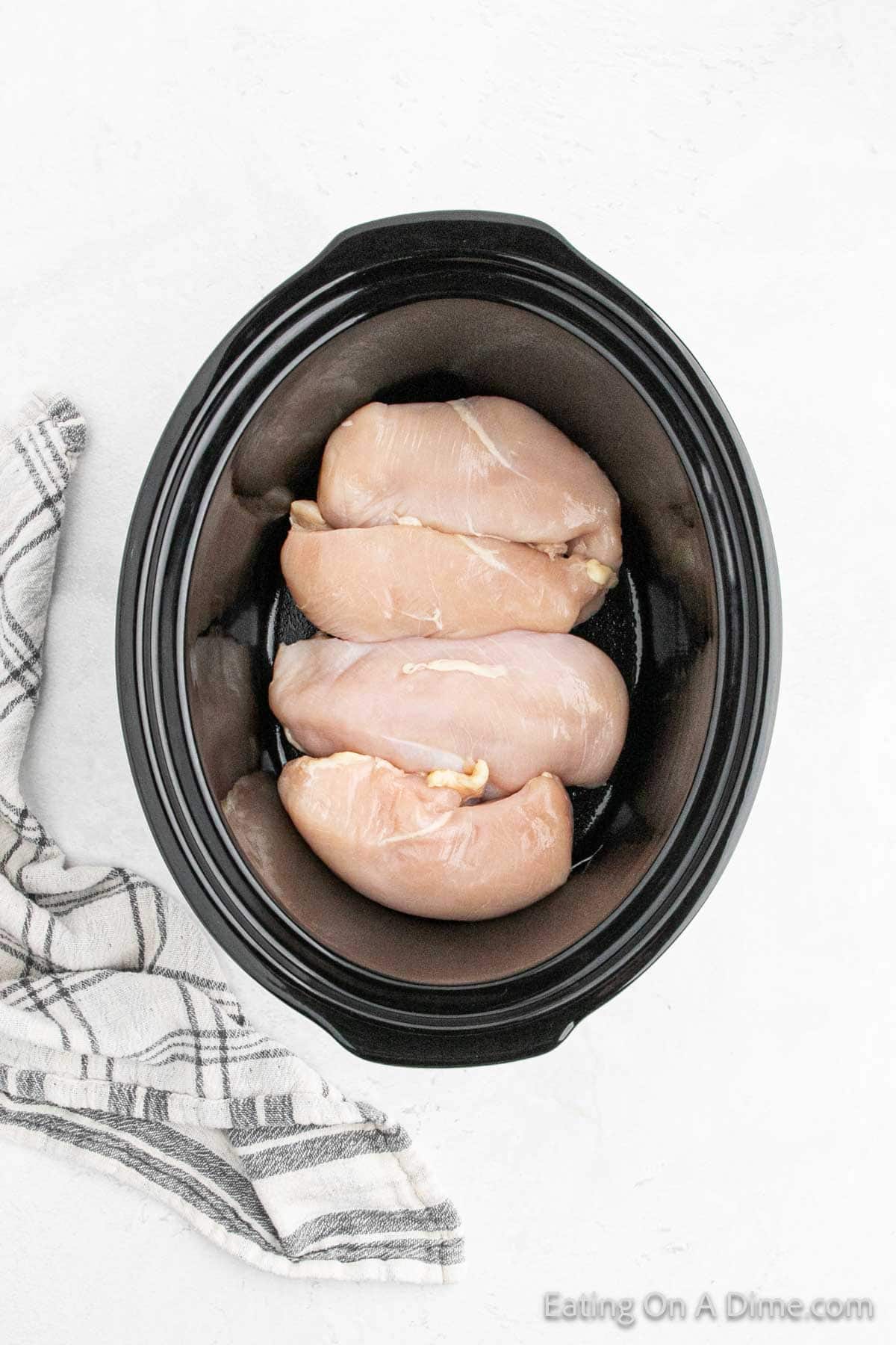 Placing chicken breast in the slow cooker