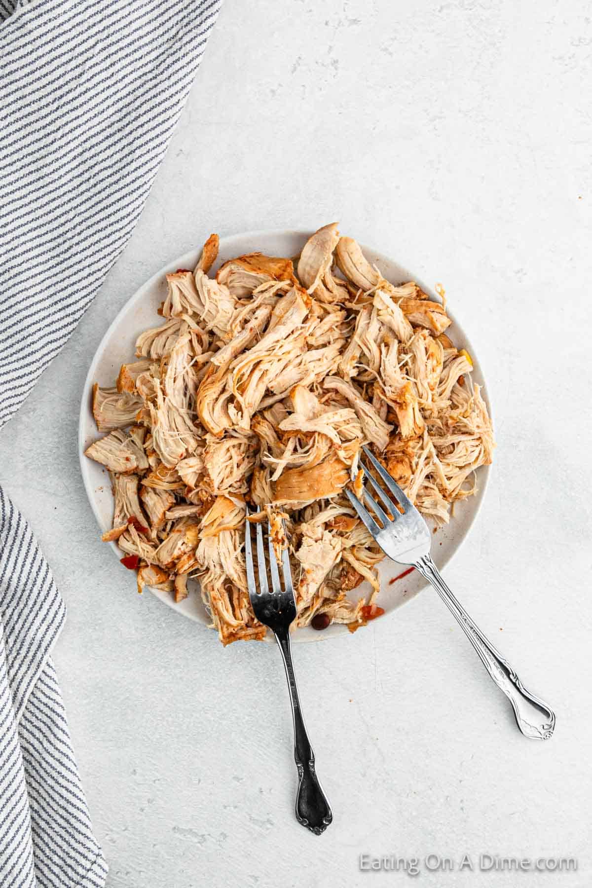 Shredded Chicken on a plate with two forks