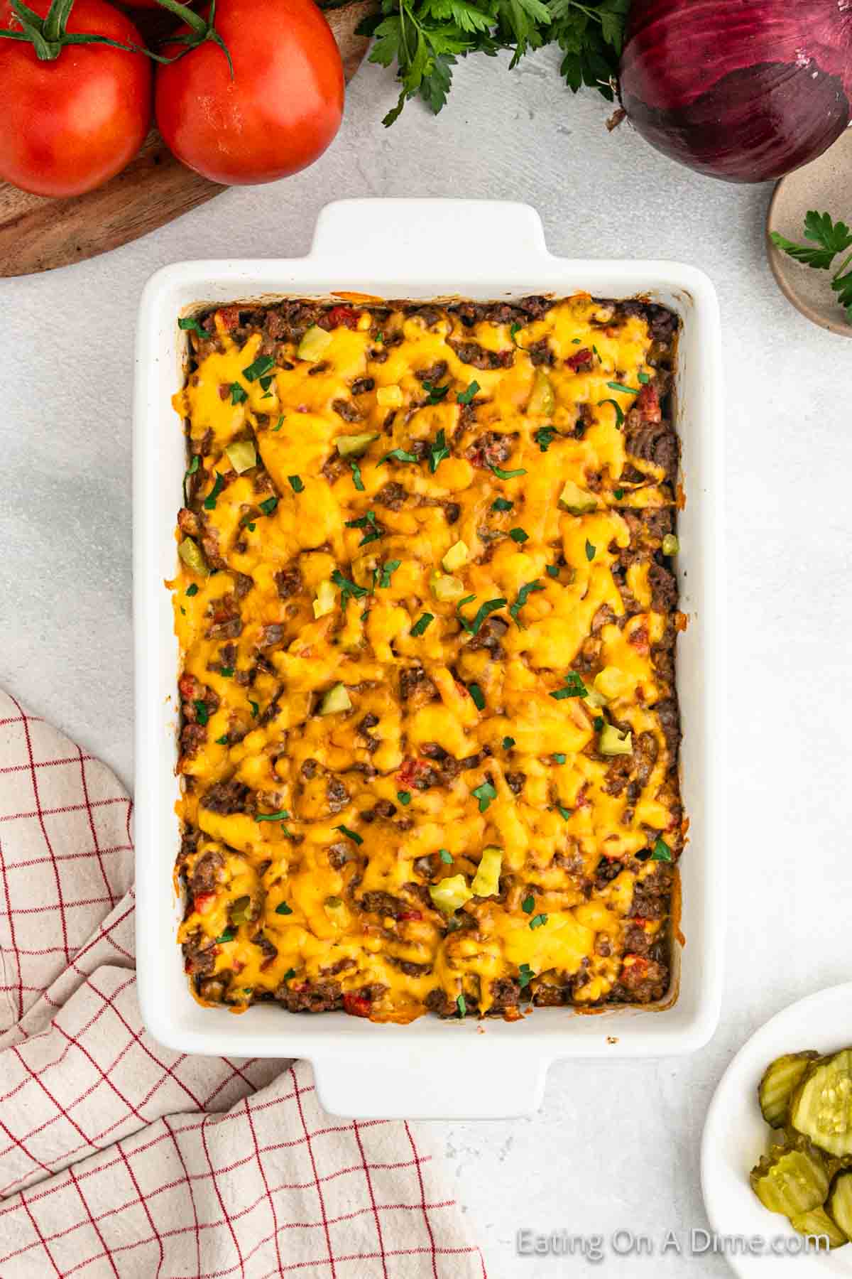 Cheeseburger Casserole in a white baking dish topped with melted cheese