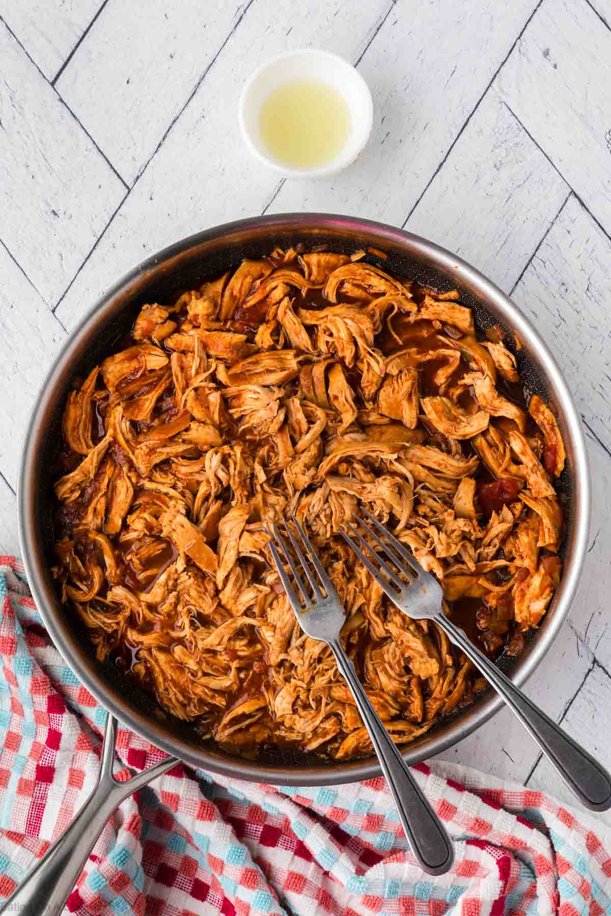 Shredded Mexican Chicken in a skillet with two forks