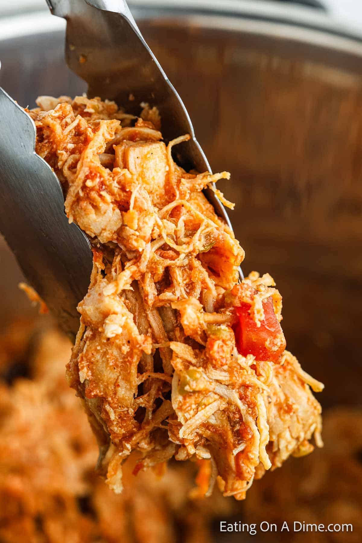 Shredded Chicken Tacos on tongs