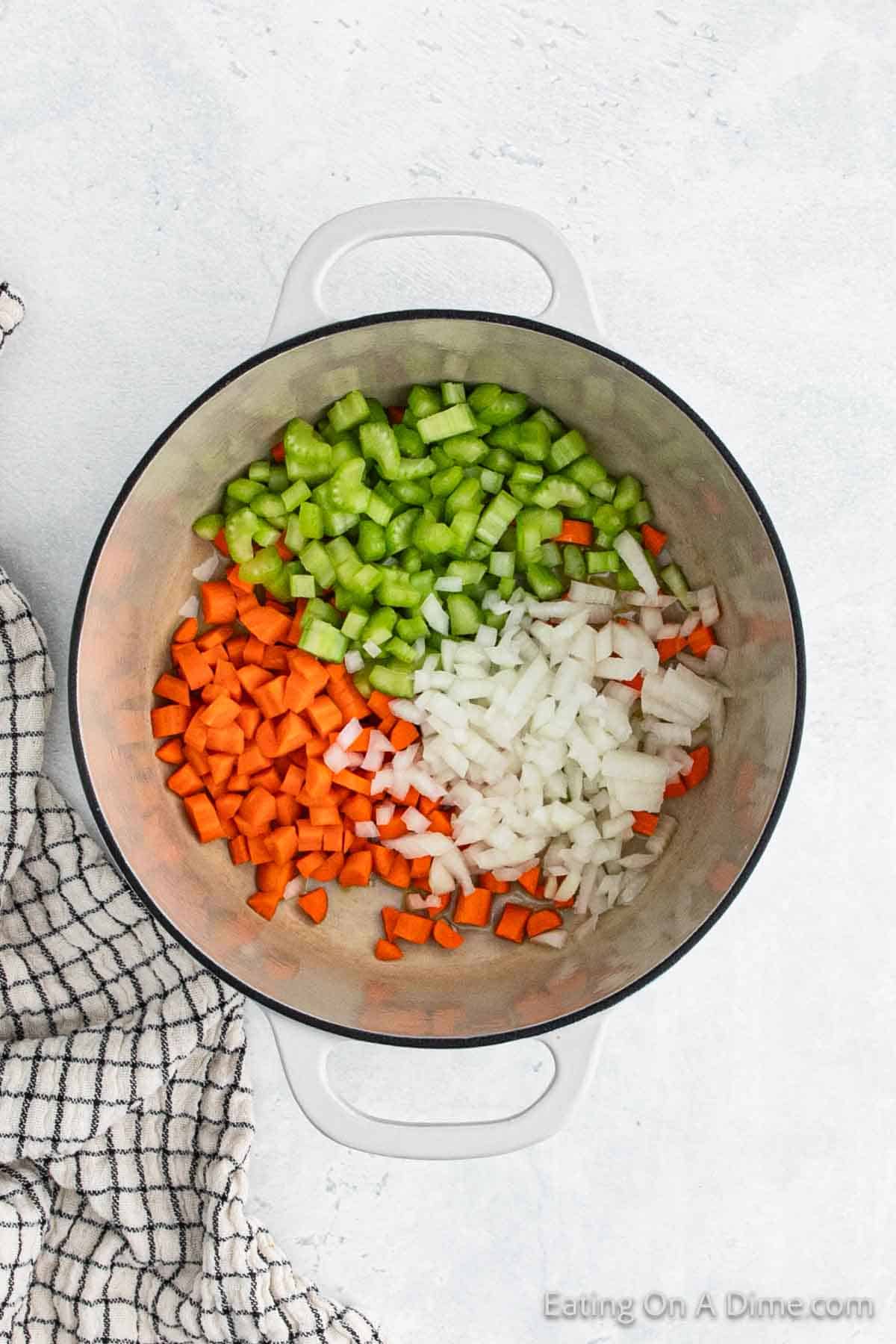 Cooking diced onions, carrots, and celery in a large pot