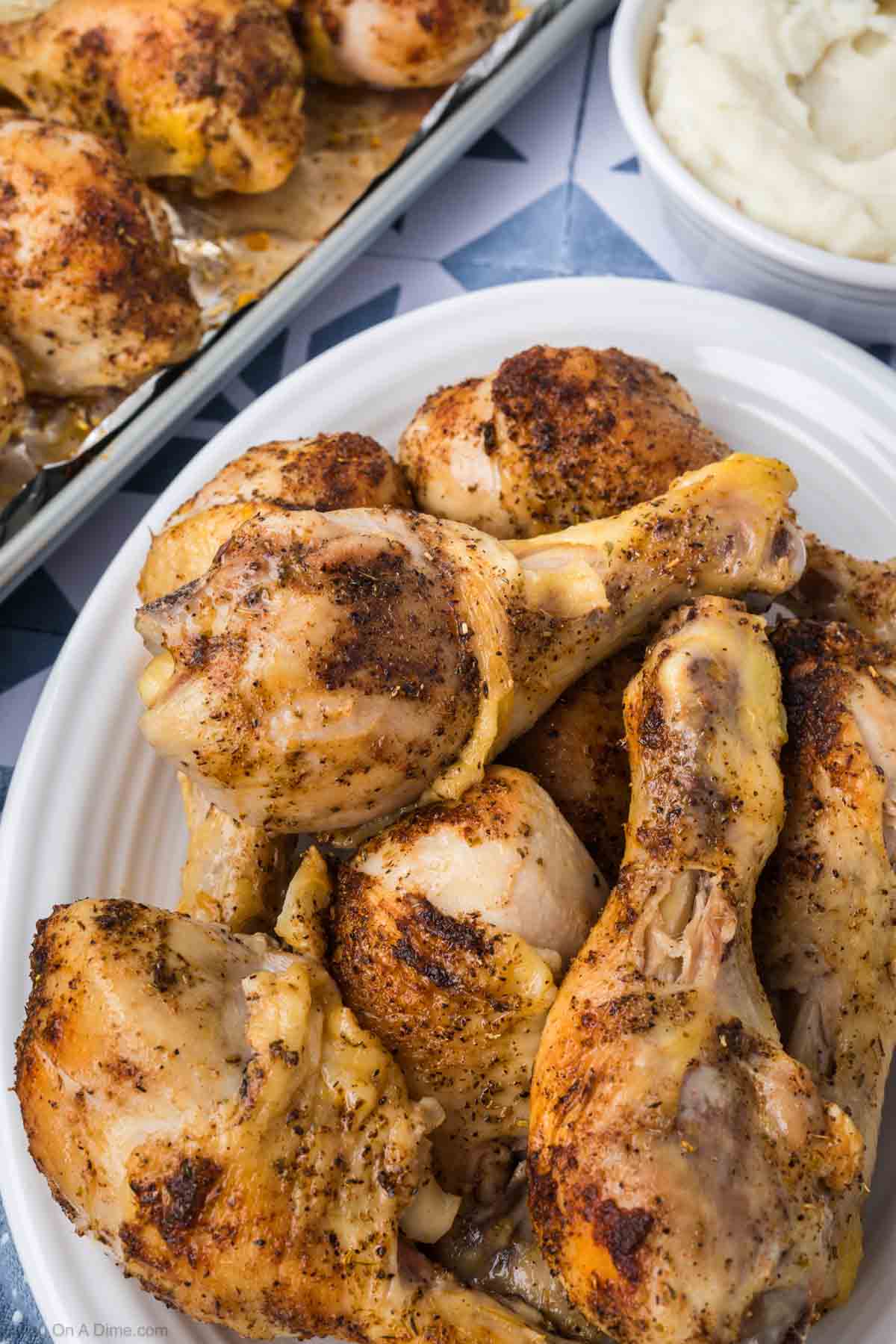 Cooked Chicken Drumsticks stacked on a platter