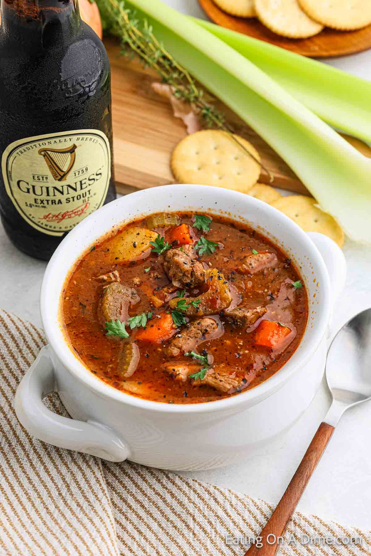 Irish Beef Stew in a bowl with a bottle of Guinness beer on the side 