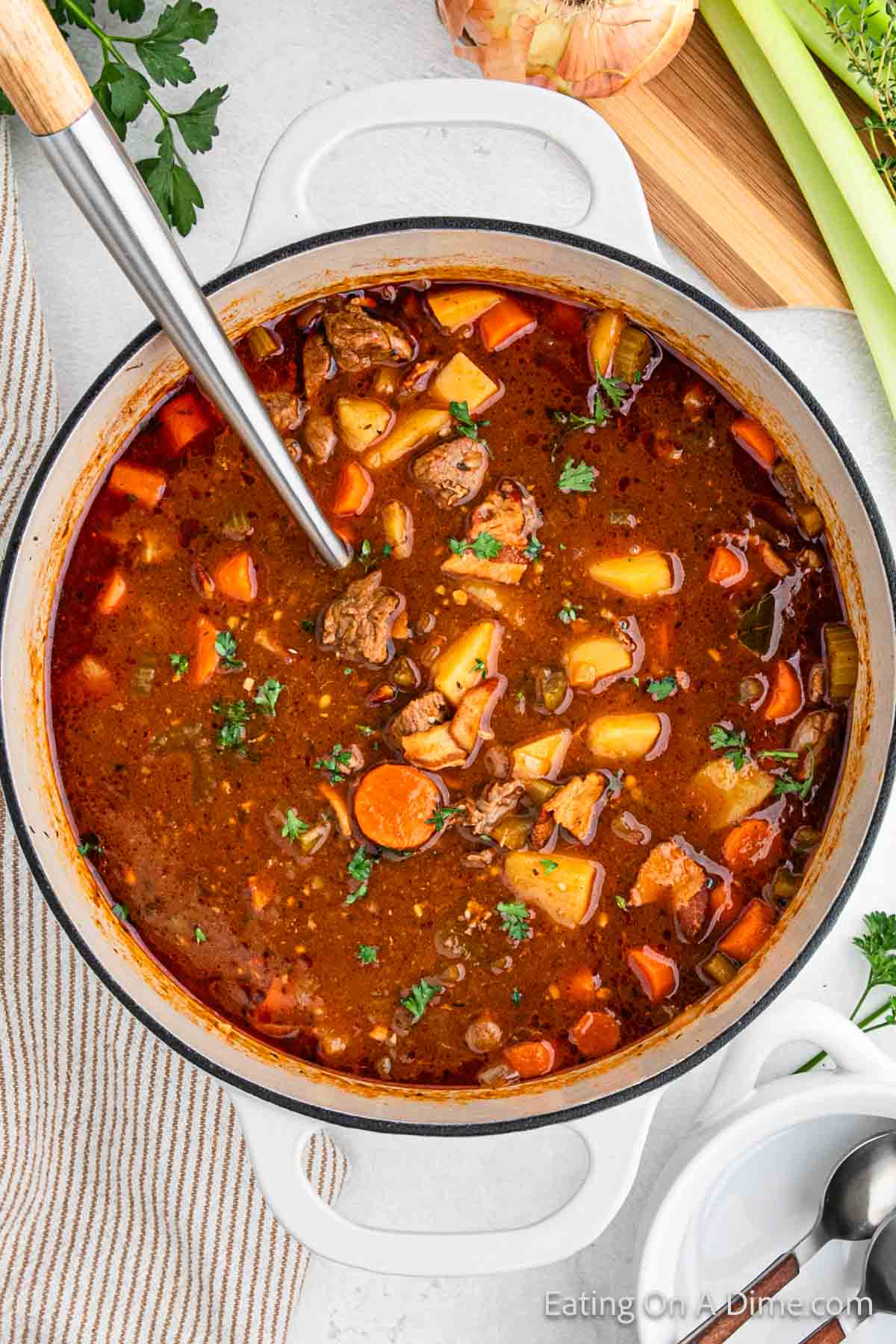 Irish beef stew in a large pot with a silver spoon