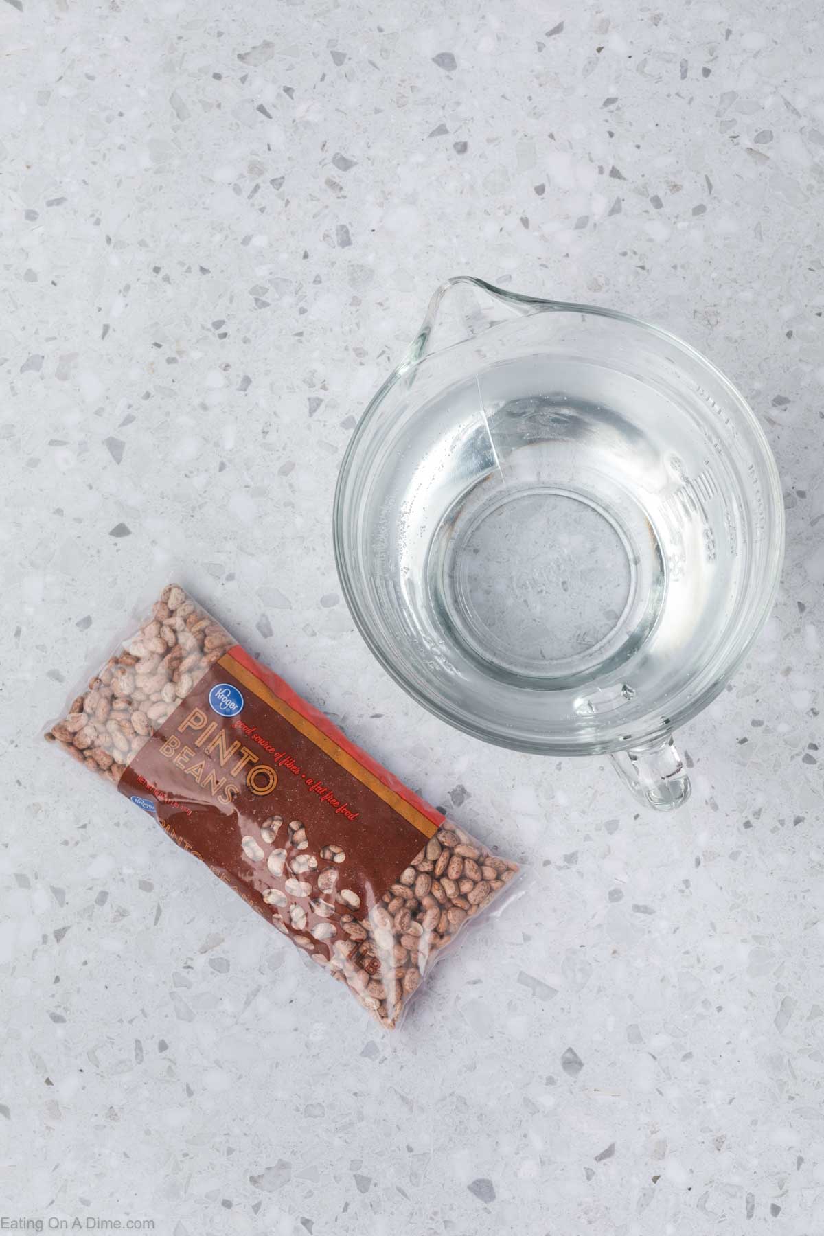 Package of pinto beans with a measuring cup of water