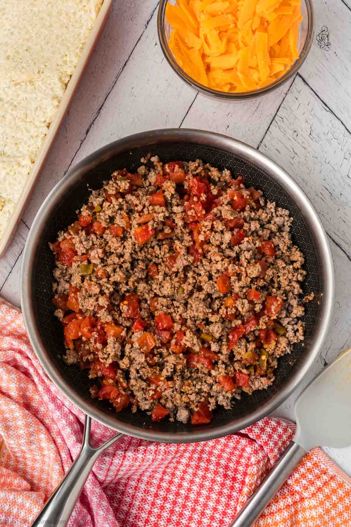 Salsa and taco seasoning mixed with the ground beef in the skillet
