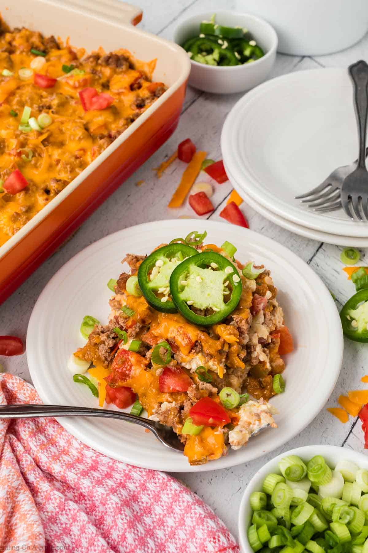 Serving of Keto Taco Casserole on a plate topped with slice jalapenos