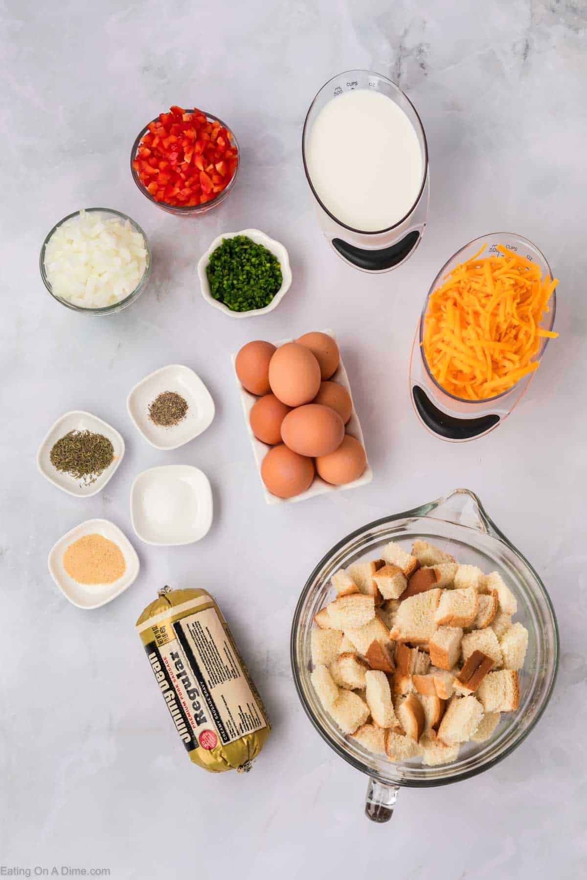 Ingredients - Breakfast Sausage, onion, red bell pepper, eggs, whole milk, thyme, garlic powder, salt, pepper, bread cubes, cheese, chives