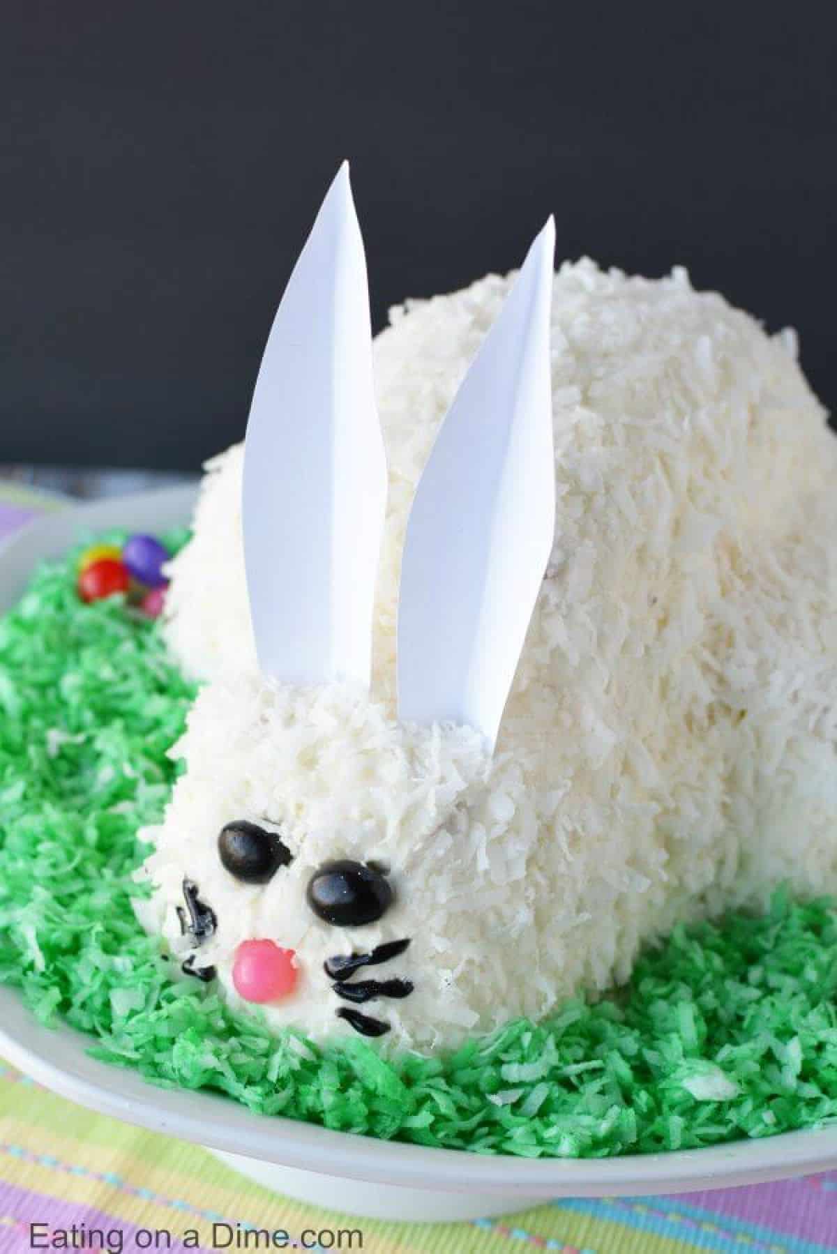 This adorable Easter Bunny Cake will be a hit! You will love how simple this easy bunny cake is. The flaky coconut and jelly beans come together to make this bunny cake recipe so cute! Try this Easter cake recipe! We love easy Easter cakes! 