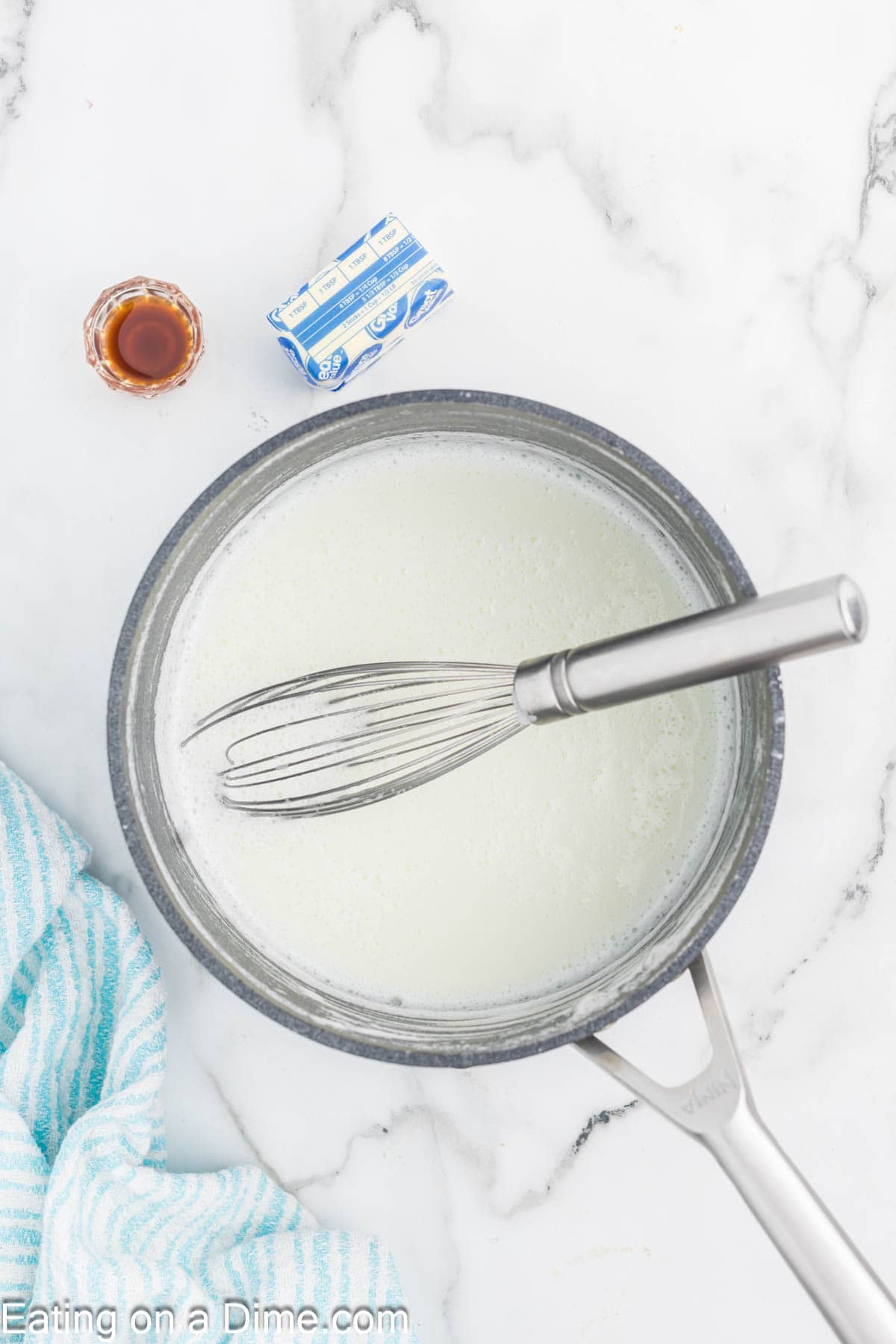 Whisking together milk and sugar in a saucepan