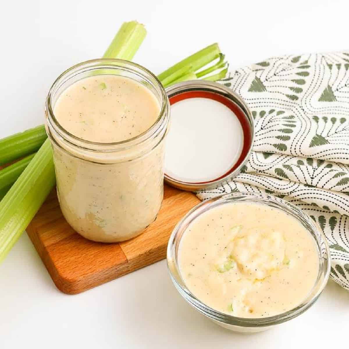 Cream of celery in a jar with a bowl of cream of celery with a side of celery sticks