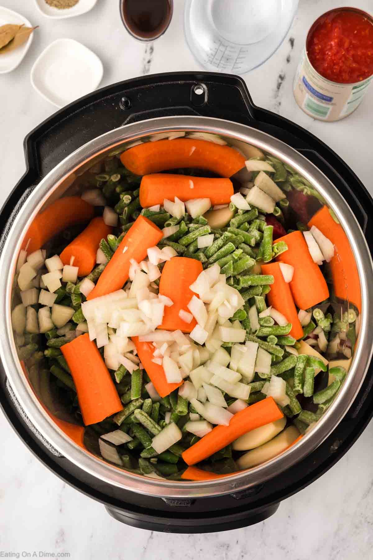 Carrots, chopped onions and frozen green beans in the instant pot