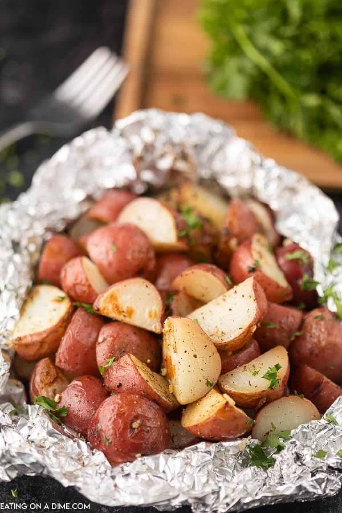 Foil pack grilled red potatoes help to make dinner a breeze without any cleanup. This is the perfect side dish for the grill or the oven. 