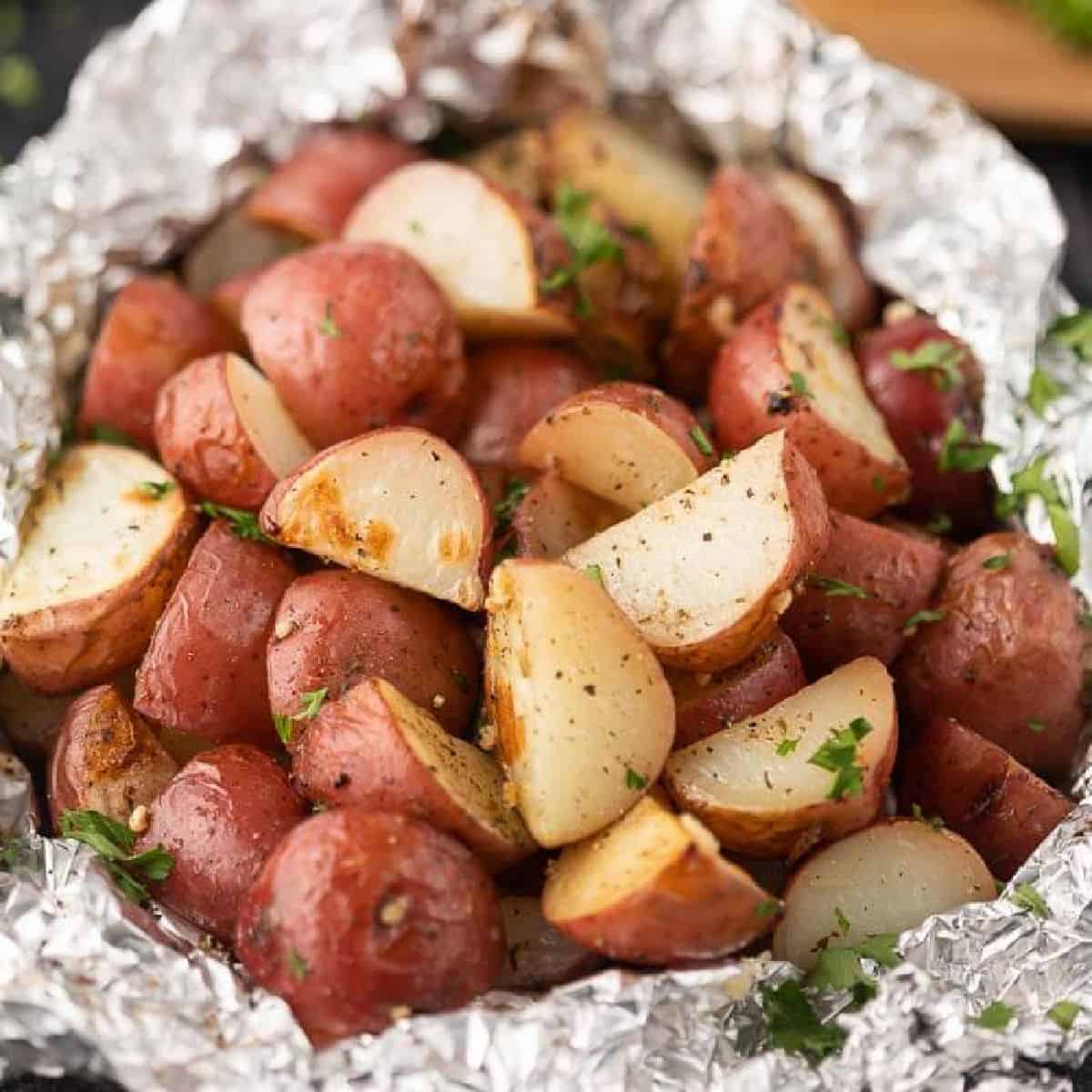 Foil pack grilled red potatoes help to make dinner a breeze without any cleanup. This is the perfect side dish for the grill or the oven. 